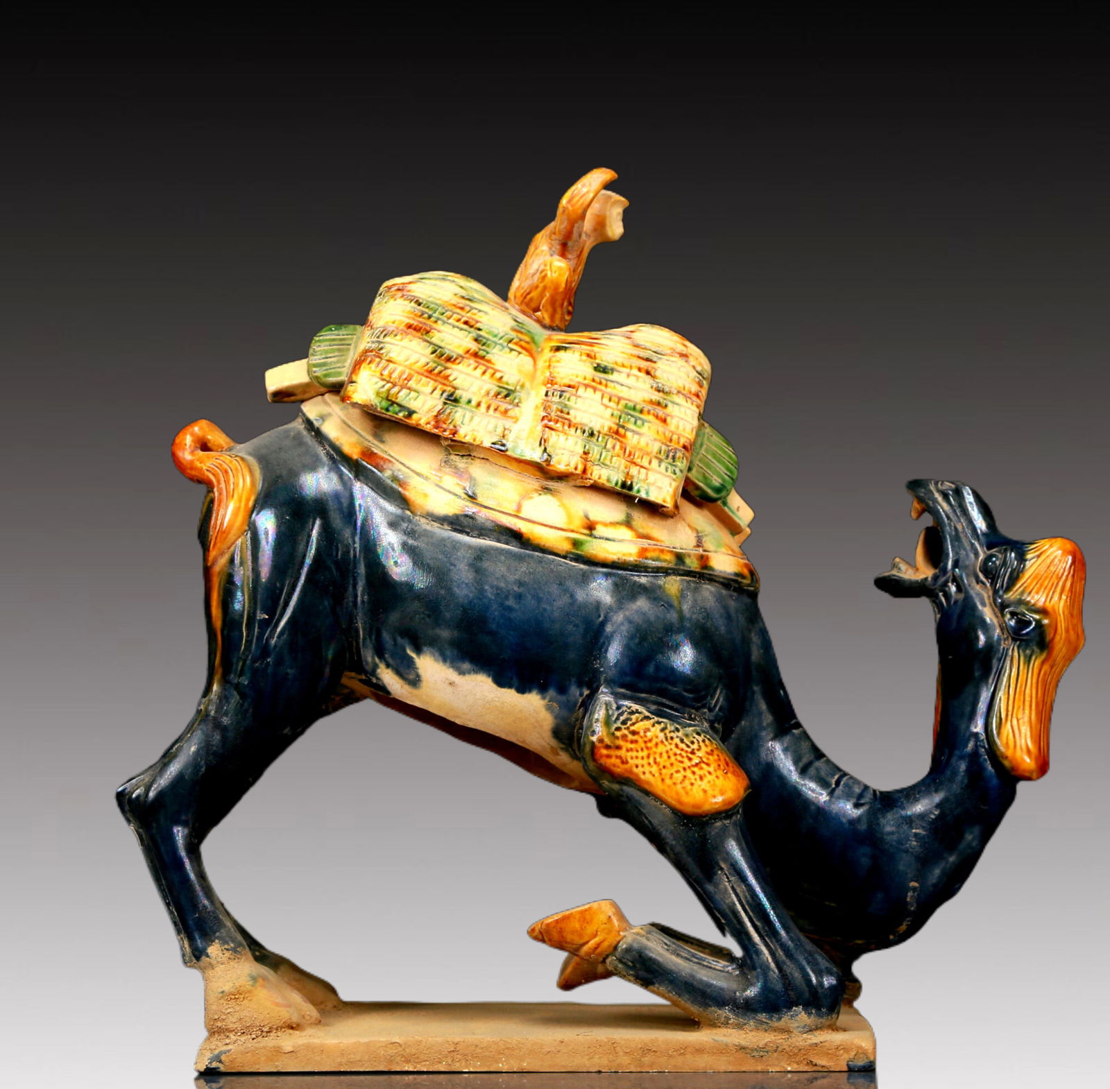 A Rare Tang Tri-Color Glazed Pottery Camel Ornament: A Rare Tang Tri-Color Glazed Pottery Camel Ornament,Tang Dynasty, China,Chinese Tang Tri-colored Pottery, or Tang Sancai, flourished during the Tang Dynasty (618–907 AD). It's renowned for its