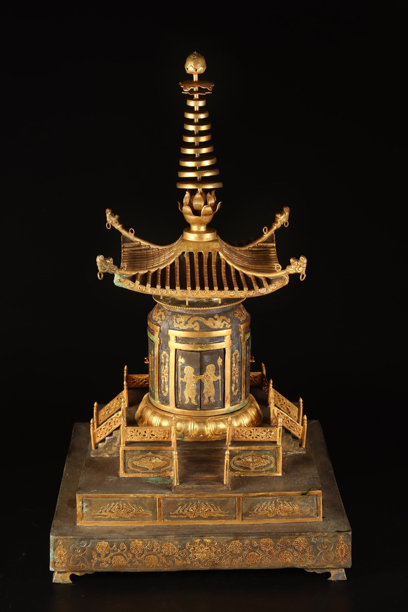 A Rare Gilt Bronze Lotus and Figure Pattern Pagoda: A Rare Gilt Bronze Lotus and Figure Pattern Pagoda ,Qing Dynasty, China,Size:17.7inx12.6in Weight:8500g 铜鎏金缠枝莲人物纹佛塔,中