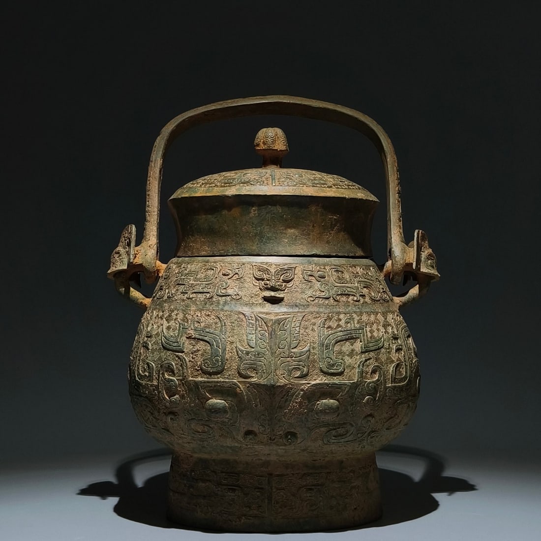 An Archaic Bronze Beast-Face Pattern Ewer: An Archaic Bronze Beast-Face Pattern Ewer,Shang Dynasty, China,Size:15inx11inx8.3in 青铜兽面纹提壶,中国商代