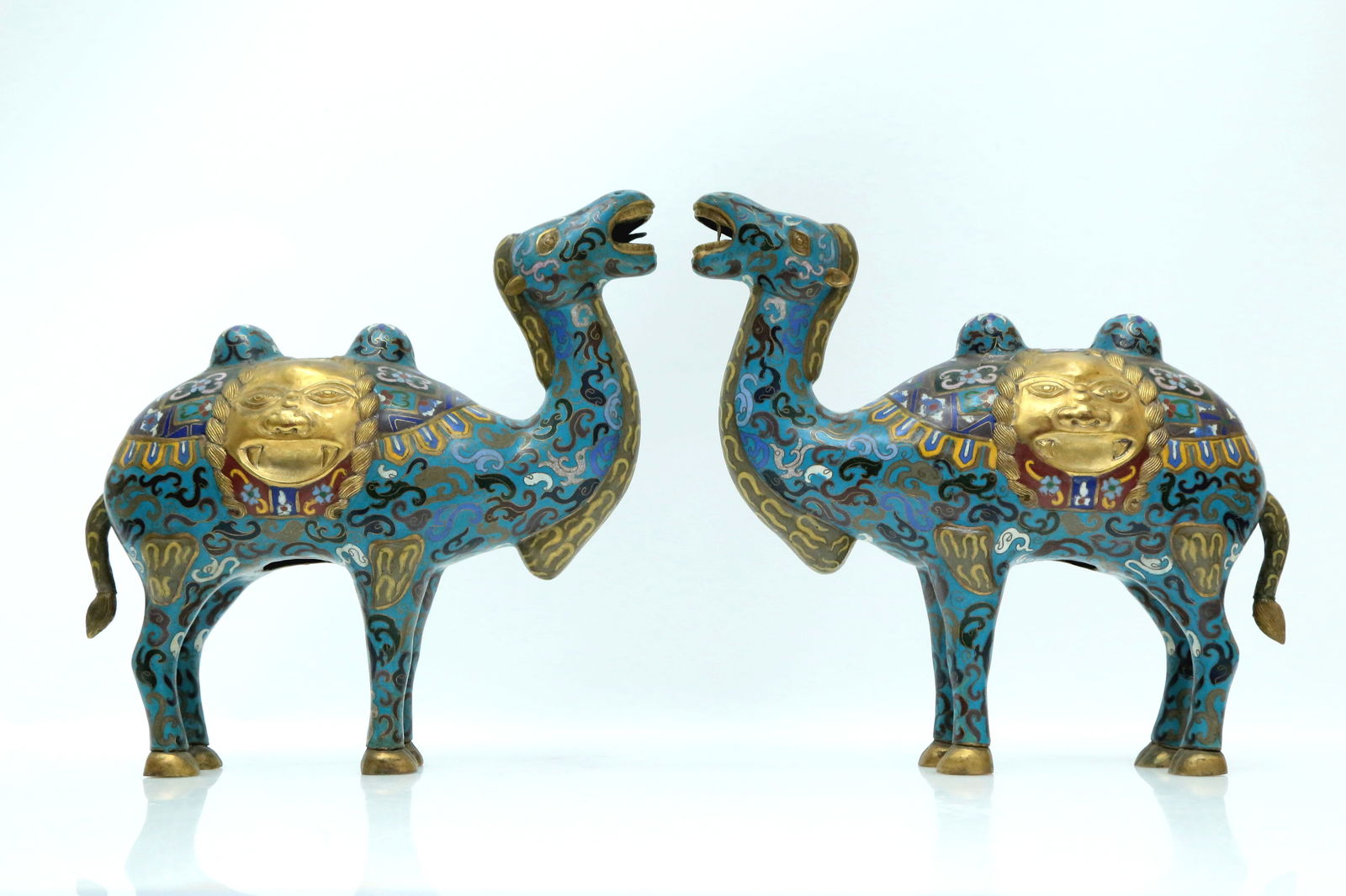 A Fine Pair Of Cloisonne Camels: A Fine Pair Of Cloisonne Camels. Each is stood foursquare, body enameled with polychrome patterns, all reserved on a bright turquoise ground. Chinese Qing Dynasty. Size:11.8inx3.9inx12.2in.