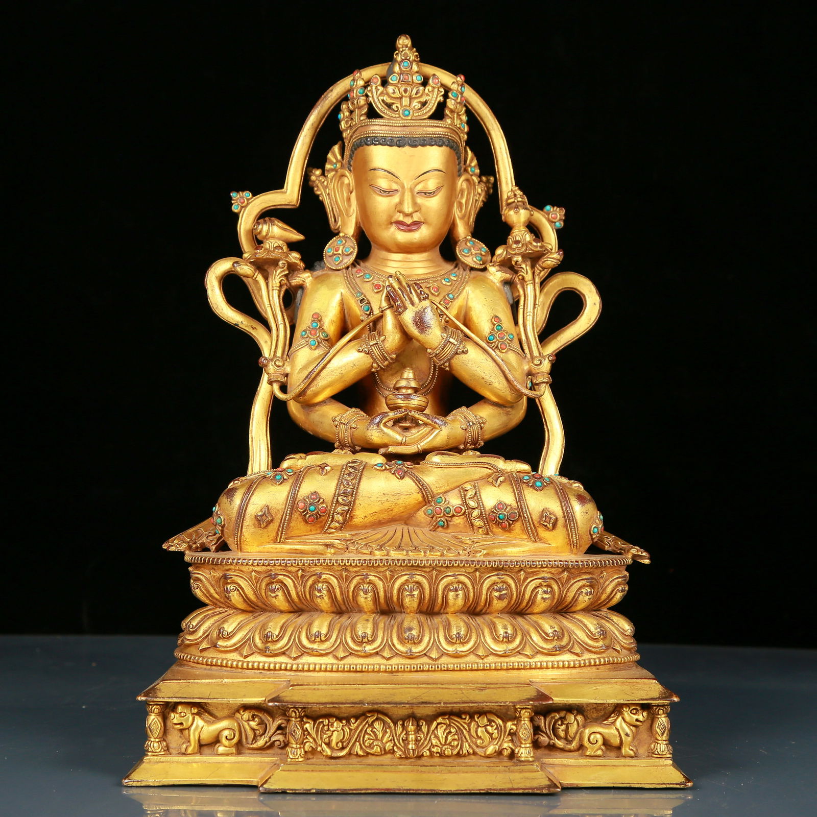 A solemn gilt bronze statue of Guanyin with four arms inlaid with precious stones: solemn gilt bronze and gem-set four-armed statue of Guanyin with mark, Ming Dynasty, China. Guanyin has a graceful posture and an expression of compassion and wisdom. Guanyin's gestures often have