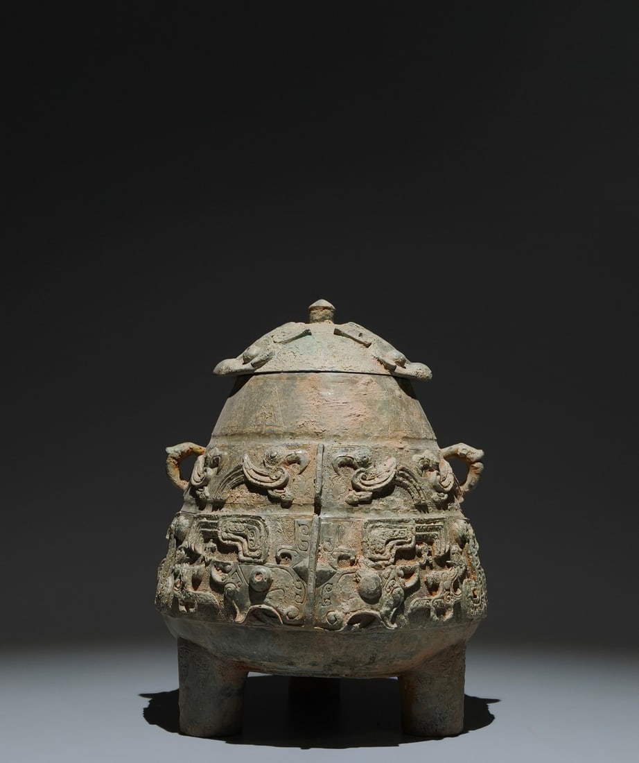 An Archaic Bronze Beast-Face and Phoenix Pattern Double-Ears and Tripod Cover Jar: An Archaic Bronze Beast-Face and Phoenix Pattern Double-Ears and Tripod Cover Jar,the Western Zhou Dynasty in China,Size:9.8inx7.5in 