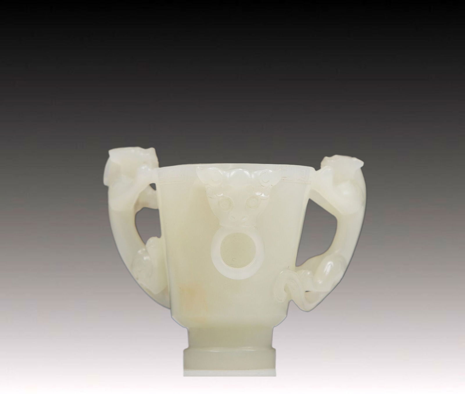 An Exquisite White Jade Chi-Dragon-Handled Cup: An Exquisite White Jade Chi-Dragon-Handled Cup. Carved with sinuous chi-dragons with curled, bifurcated tails. Chinese Qing Dynasty. Size:2.9inx1.7inx2.1in. Weight:115g