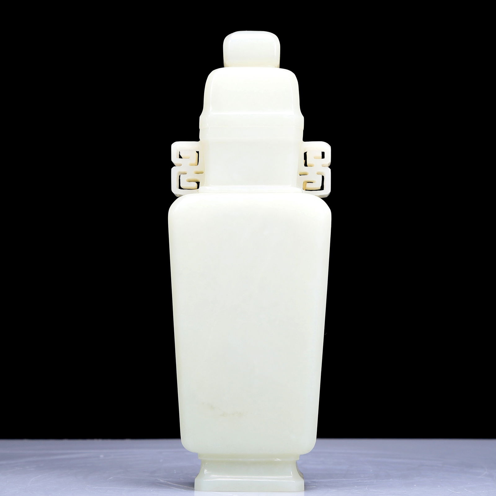A Precious White Jade Vase And Cover: A Precious White Jade Vase And Cover. Supported on a subtly splayed foot, handles with angular scrolls. Chinese Qing Dynasty. Size:3.3inx2inx9.1in. Weight:685g 清代 白玉双
