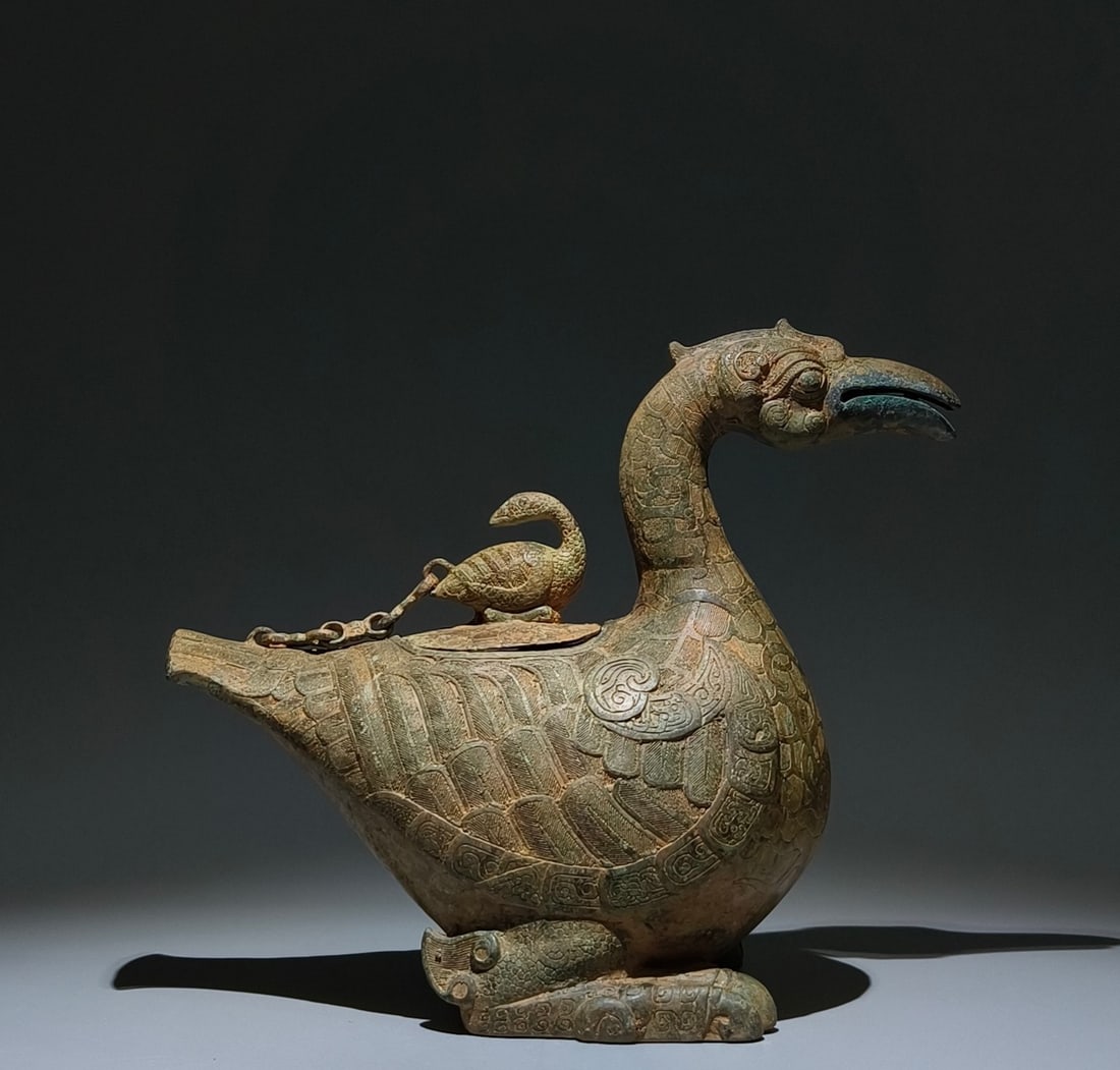 An Archaic Bronze Duck-Shaped Zun,With Inscription: An Archaic Bronze Duck-Shaped Zun,With Inscription,the Warring States period in China,Size:10.6inx12.6inx6.7in 青铜鸭形尊,带铭文,中国战