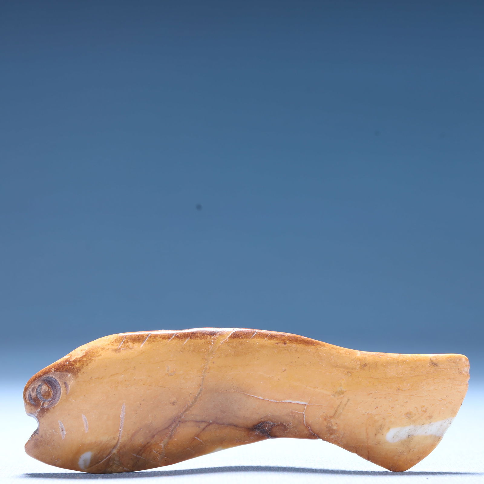 An Archaic Hongshan Culture Yellow Jade Fish Ornament: An Archaic Hongshan Culture Yellow Jade Fish Ornament,Ancient Time,China,Size:4.2inx0.6inx1.4in,Weight:57.1g 红山文化黄玉鱼摆件,中国&#
