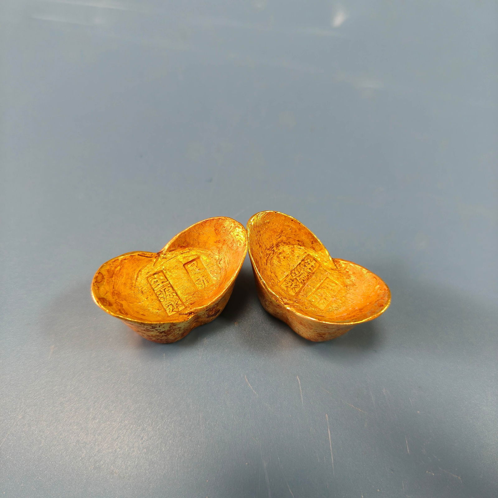 A pair of Exquisite Bronze Gilt Gold Ingot: A pair of Exquisite Bronze Gilt Gold Ingot,Qing Dynasty, China,Size:1.3inx0.7in,Weight:68g 一对铜鎏金金元宝,中国清代