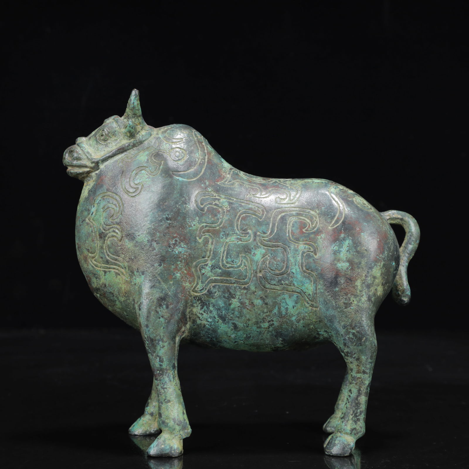An Archaic Bronze Buffalo Ornament: An Archaic Bronze Buffalo Ornament,the Warring States Period in China,Size:5.9inx2.4inx6.3in,Weight:750g 青铜牛摆件,中国战国时期