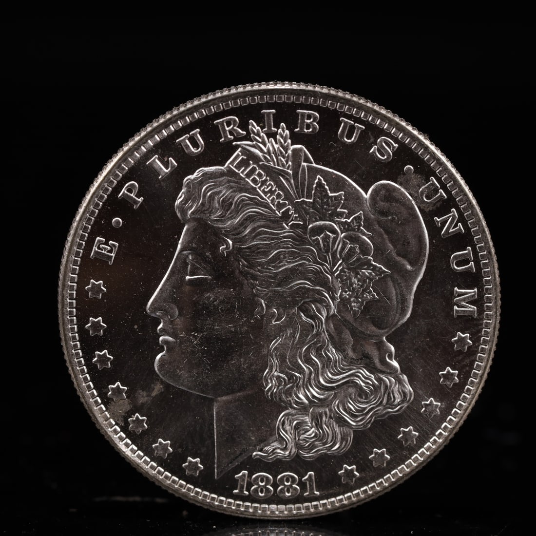 USA Morgan Dollar 1881 Coin: Obv: profile bust with date below and E PLURIBUS UNUM legend and stars around. Rev: eagle with In God we trust above within wreath with UNITED STATES OF AMERICA ONE DOLLAR legend. IN GOD WE TRUST /