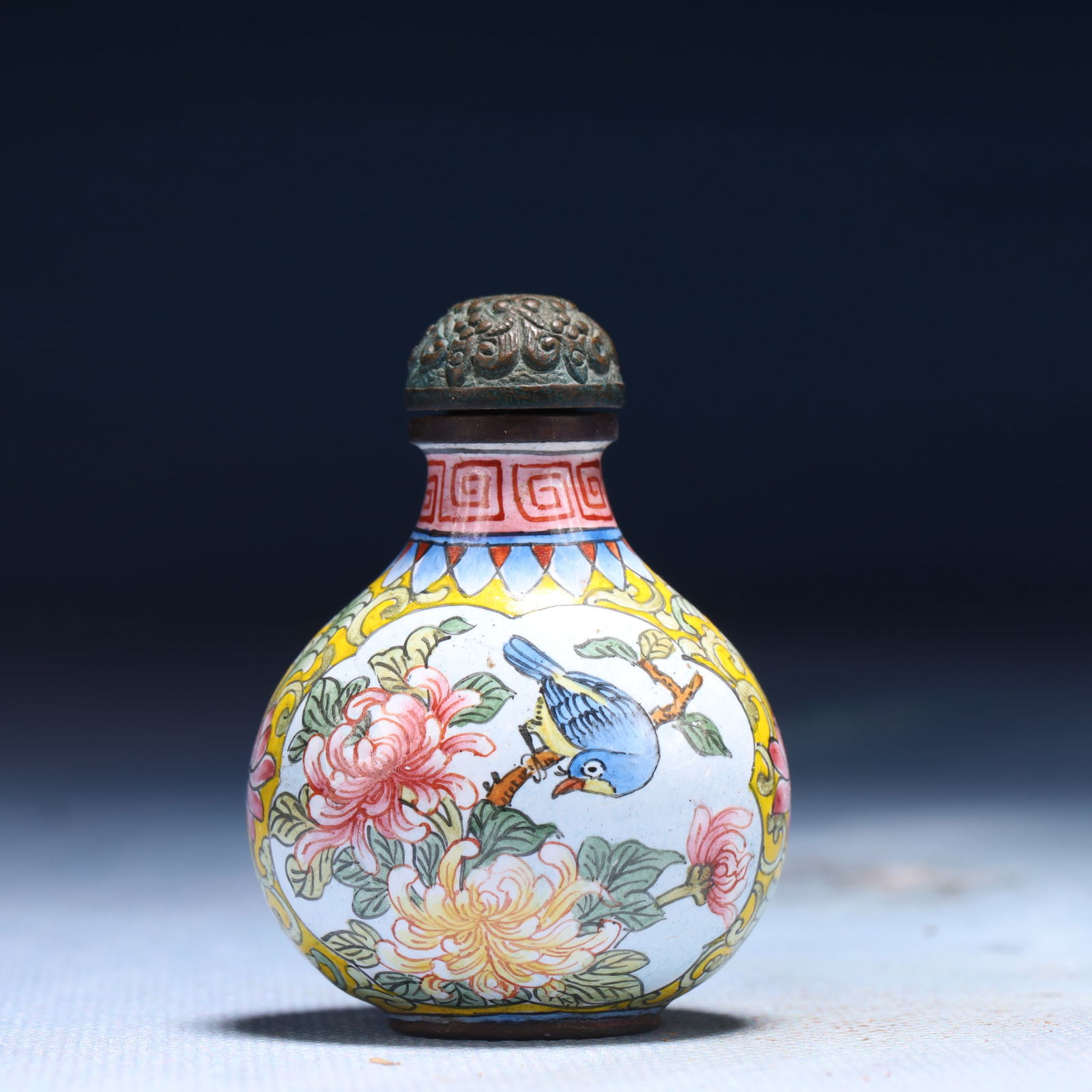An Exquisite Painted Enamel Flower and Bird Pattern Snuff Bottle: An Exquisite Painted Enamel Flower and Bird Pattern Snuff Bottle,Qing Dynasty,China,Qianlong Four-character Mark,Size:1.6inx1inx2in,Weight:41g 
