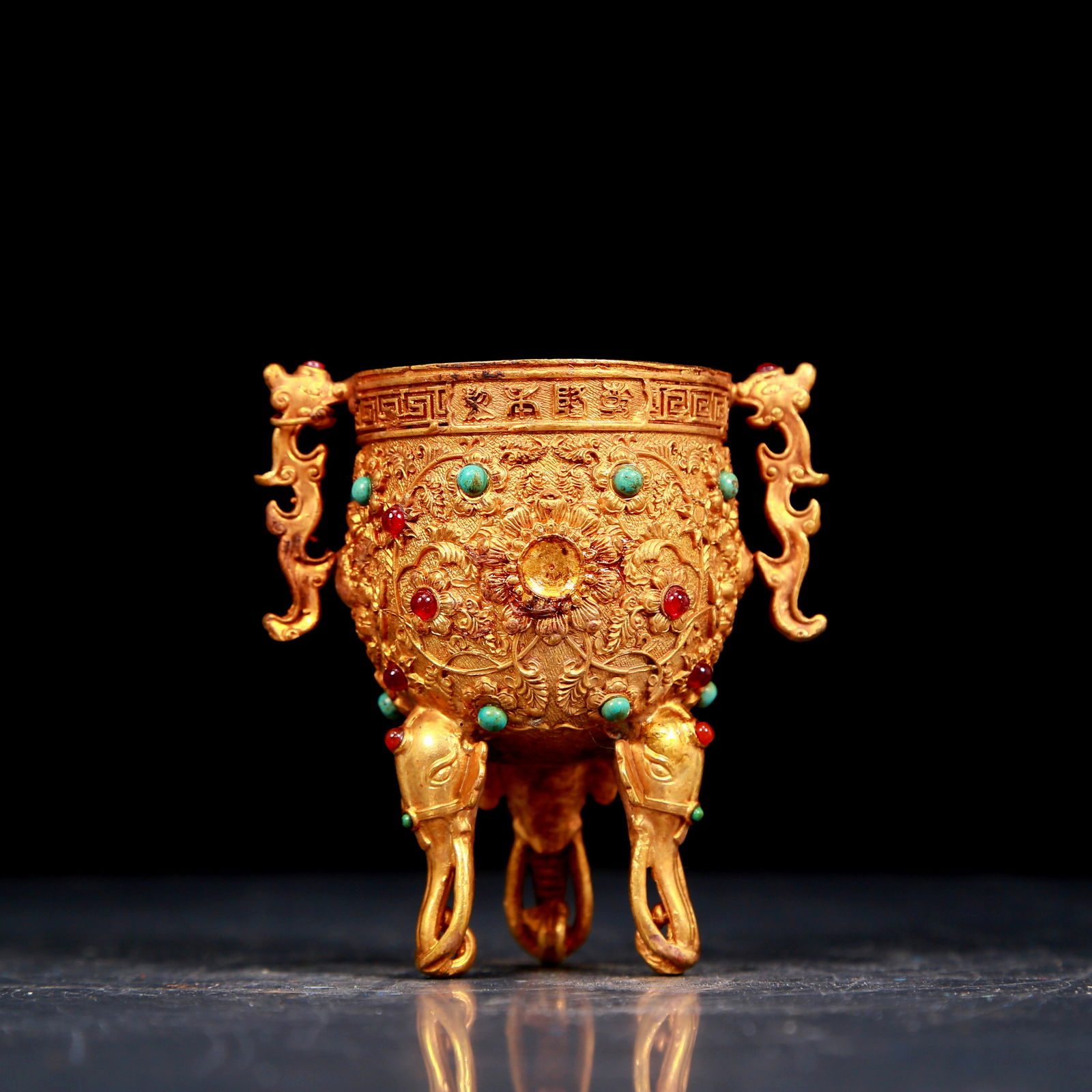 An exquisite gilt bronze cup with double ears, tripod and dragon pattern inlaid with gems: An exquisite gilt bronze cup with double ears and tripod and chilong pattern inlaid with gems, inlaid with gems, from the Qing Dynasty of China. The surface has been carefully carved, vividly