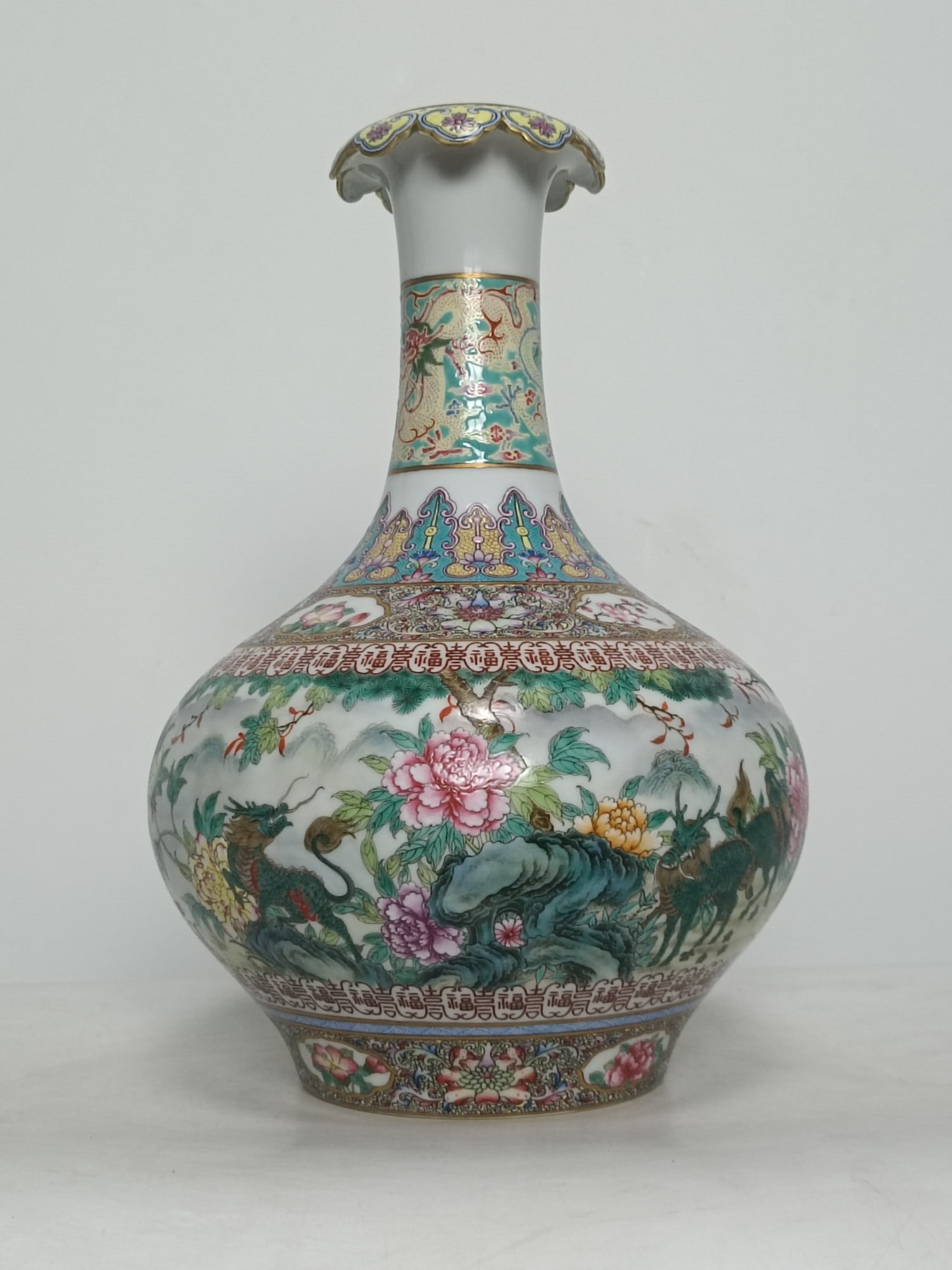 A Rare Enamel Flower and Kylin Pattern Vase: A Rare Enamel Flower and Kylin Pattern Vase,Qing Dynasty,China,Qianlong Six-character Mark,Size:13.4inx9.3in 