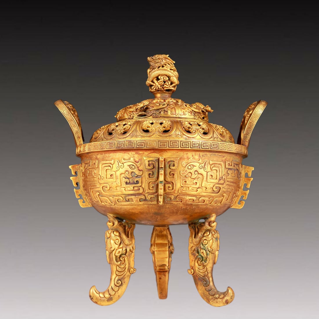 An exquisite gilt bronze dragon-patterned double-eared and three-legged furnace: An exquisite gilt bronze double-eared and three-legged stove with dragon pattern, Qianlong four-character design, Qing Dynasty, China, Size: 8.7inx7.5inx9.8in Weight: 2710g 