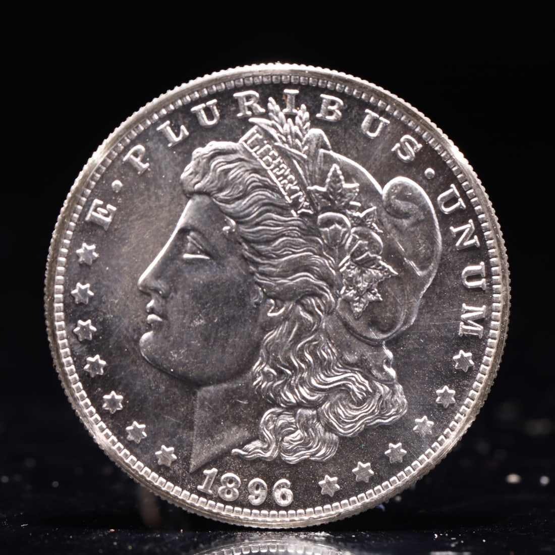 USA Morgan Dollar 1896 Coin: Obv: profile bust with date below and E PLURIBUS UNUM legend and stars around. Rev: eagle with In God we trust above within wreath with UNITED STATES OF AMERICA ONE DOLLAR legend. IN GOD WE TRUST /