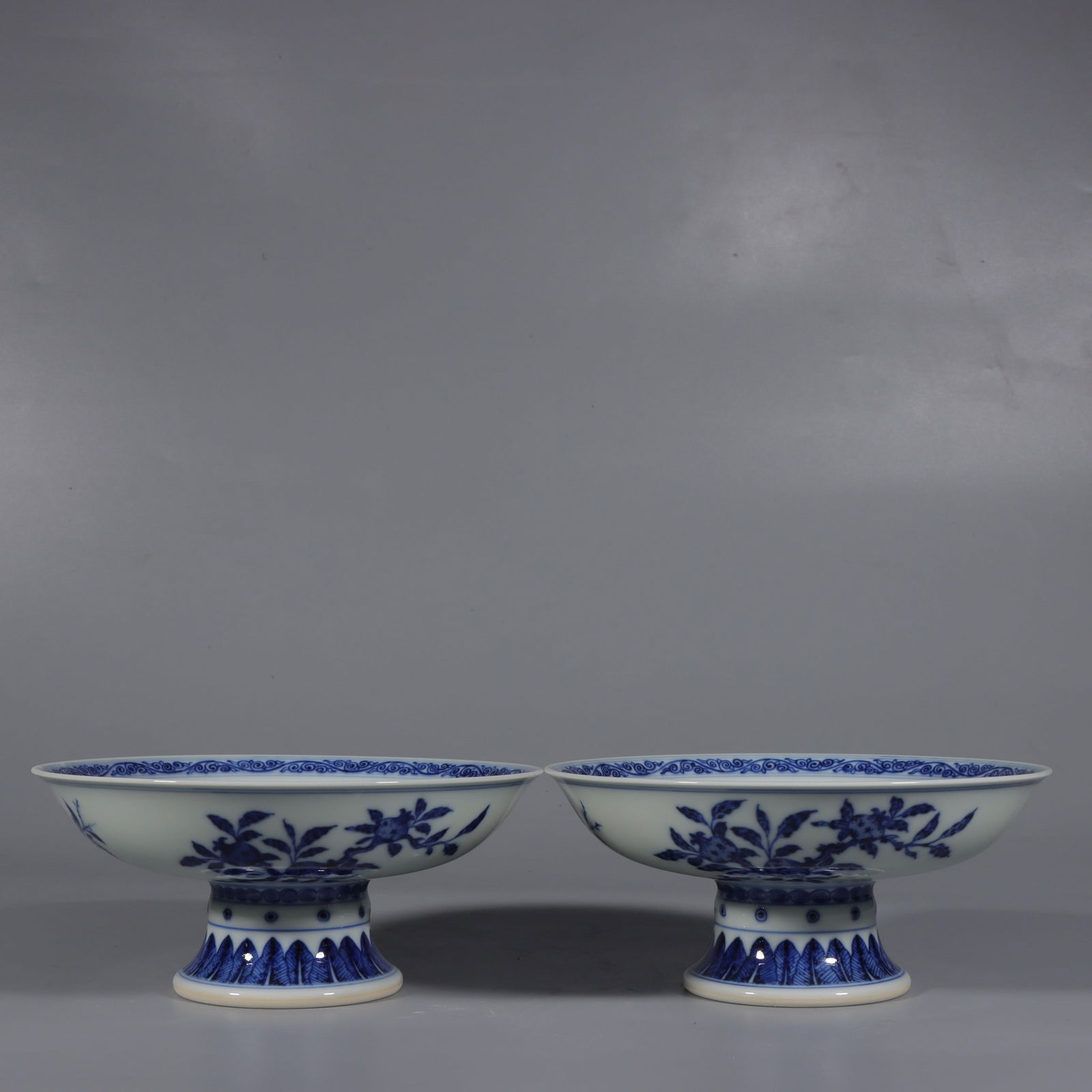 A Pair of Exquisite Blue and White Flower and Fruit Pattern Stem Plates: A Pair of Exquisite Blue and White Flower and Fruit Pattern Stem Plates,Qing Dynasty,China,Qianlong Six-character Mark,Size:3inx6.7in 一对青花花果纹高&#