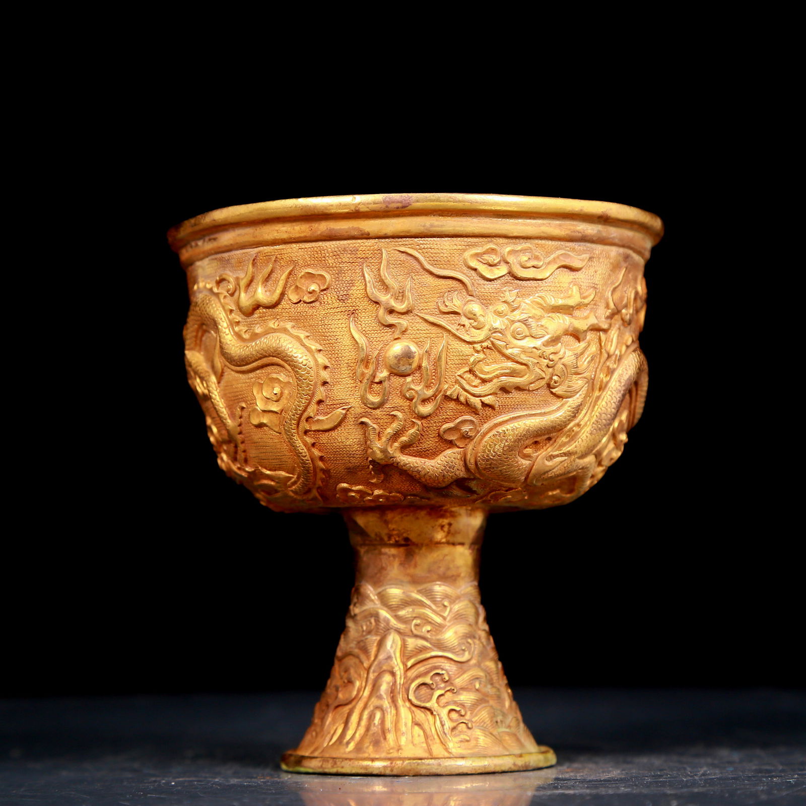 An exquisite gilt bronze cup with dragon pattern: An exquisite gilt bronze cup with dragon pattern, Qing Dynasty, China. The surface has been carefully carved, vividly demonstrating the superb skills of the craftsman. It has its own unique meaning an