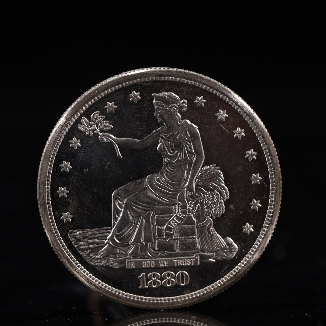 USA Trade Dollar 1880 Coin: American coin. Obverse: Liberty seated on a pedestal facing the sea to the left holding olive branches surrounded by 13 stars. IN GOD WE TRUST / LIBERTY / 1880. Reverse: An eagle holding branches