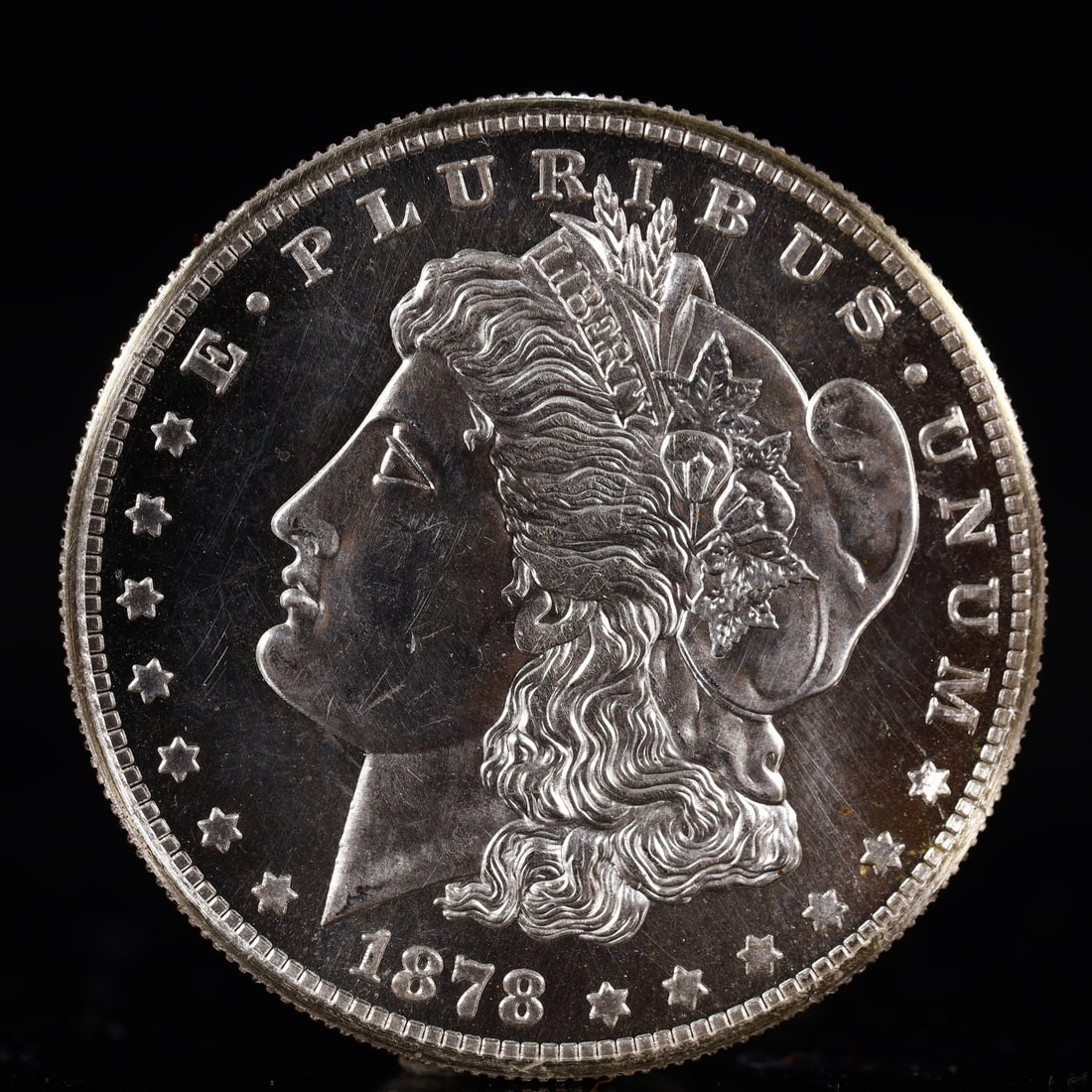 USA Morgan Dollar 1878 Coin: Obv: profile bust with date below and E PLURIBUS UNUM legend and stars around. Rev: eagle with In God we trust above within wreath with UNITED STATES OF AMERICA ONE DOLLAR legend. IN GOD WE TRUST /