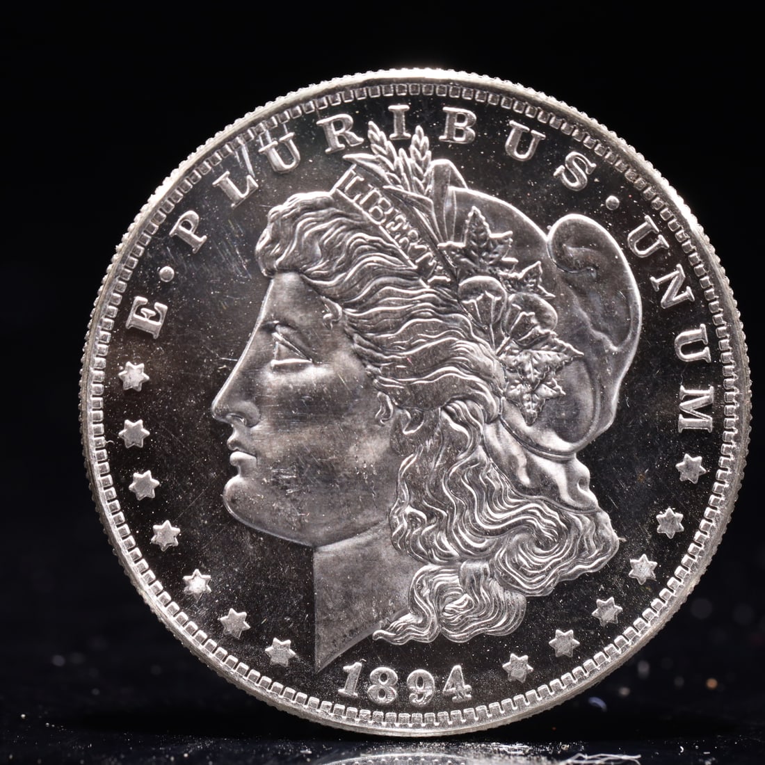 USA Morgan Dollar 1894 Coin: Obv: profile bust with date below and E PLURIBUS UNUM legend and stars around. Rev: eagle with In God we trust above within wreath with UNITED STATES OF AMERICA ONE DOLLAR legend. IN GOD WE TRUST /