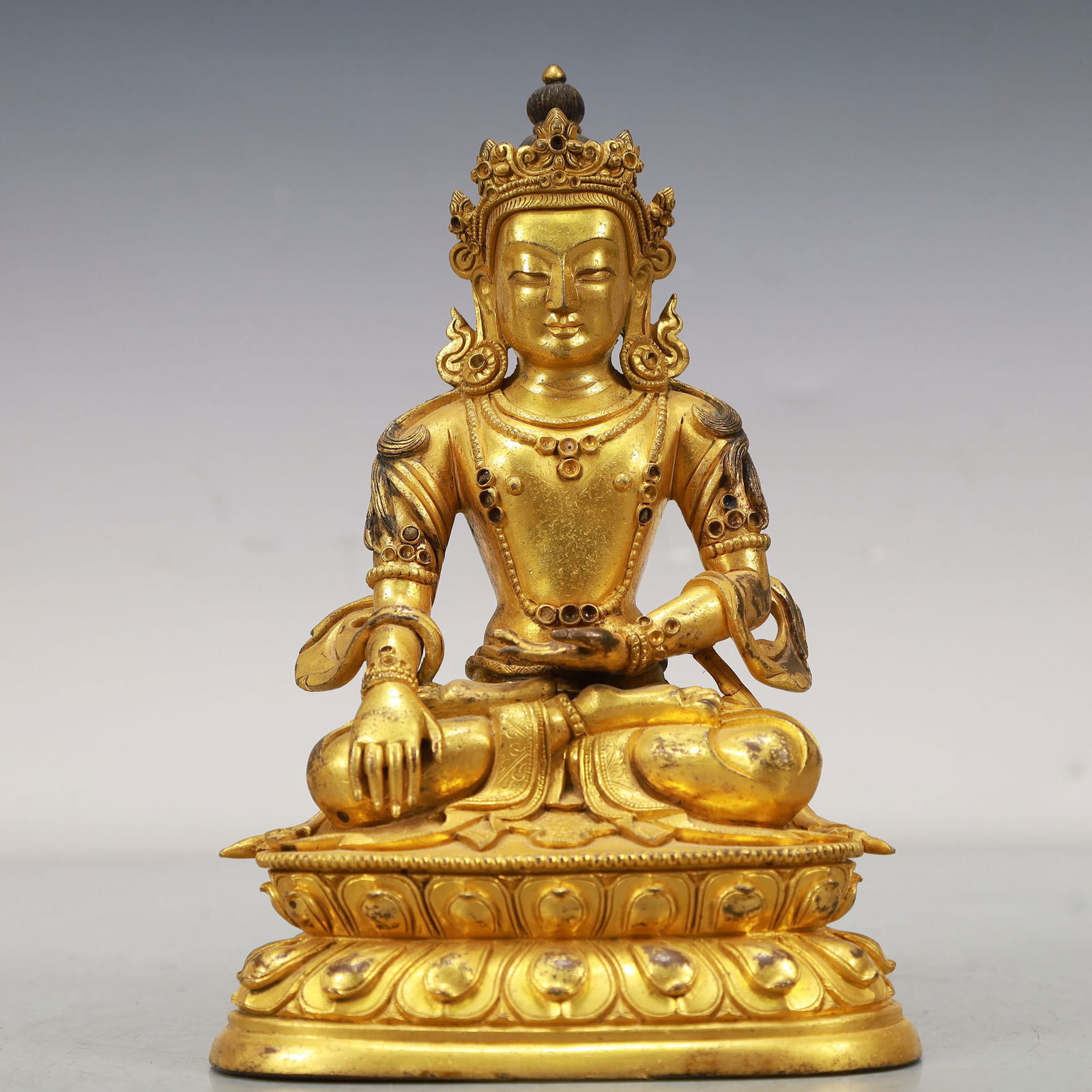 An Excellent Gilt-Bronze Figure Of Longevity Buddha: An Excellent Gilt-Bronze Figure Of Longevity Buddha. Seated on a base with a peaceful expression,body adorned with jewelry ornaments,topknot surmounted by a splendid diadem. Chinese Qing Dynasty.