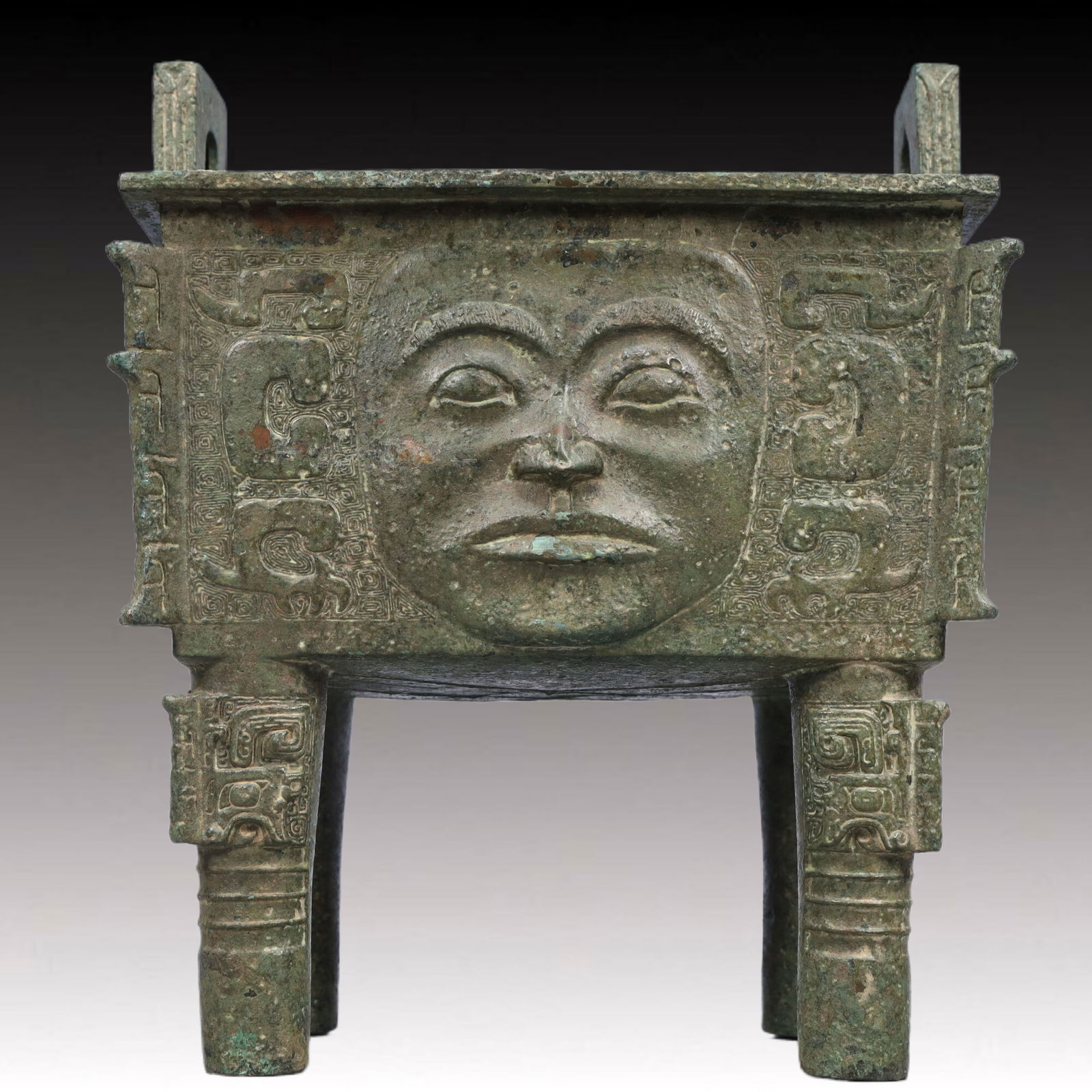 A Rare Bronze Face Pattern Double-Ears Censer: A Rare Bronze Face Pattern Double-Ears Censer,Ancient Time, China,Size:7.5inx8.5inx14in ;Weight:9250g 青铜人脸纹双耳四足香炉，&#