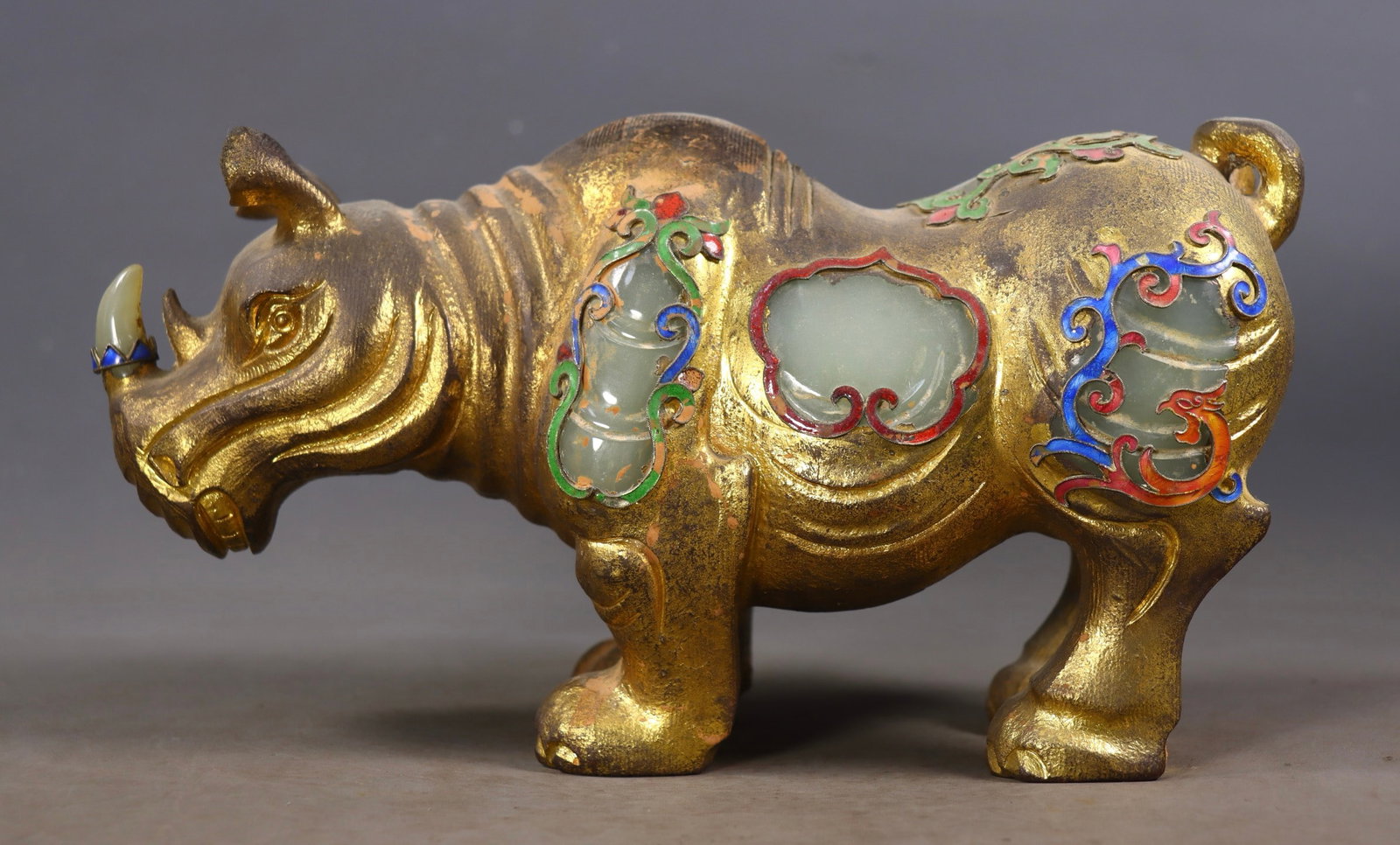 A Exquisite Hetian Jade Gold-Covered Inlaid Gems Rhinoceros: A Exquisite Hetian Jade Gold-Covered Inlaid Gems Rhinoceros,Qing Dynasty, China,Size:5.5inx9.6inx3.7in,Weight:3928g 和田玉包金嵌宝石犀牛,