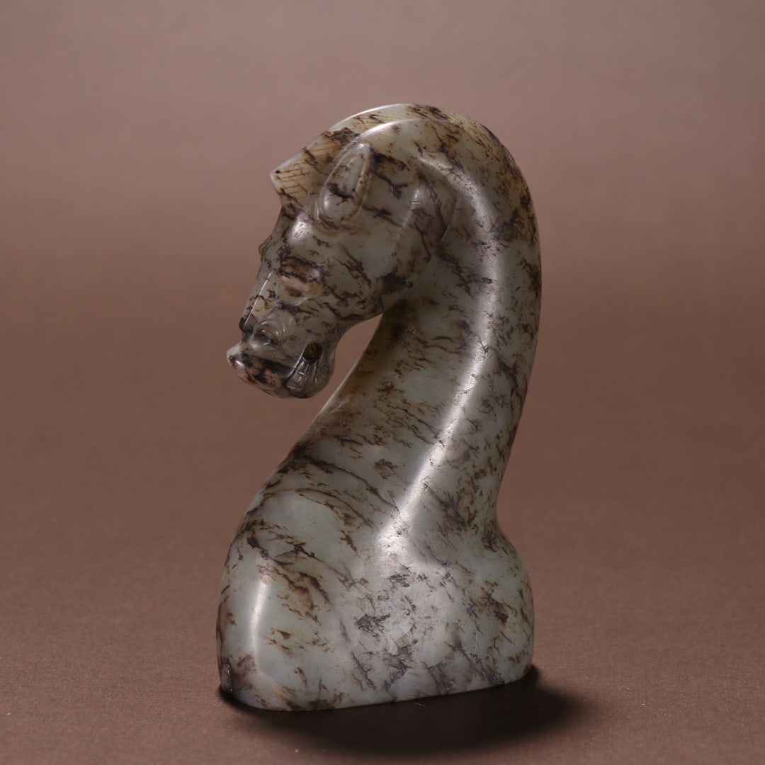 An Exquisite White Jade Horse Ornament: An Exquisite White Jade Horse Ornament Han Dynasty, China Size:2.6inx2.2in Weight:256.4g白玉马首 中国汉代 Size:6.7cmx5.5cm Weight:256.4g