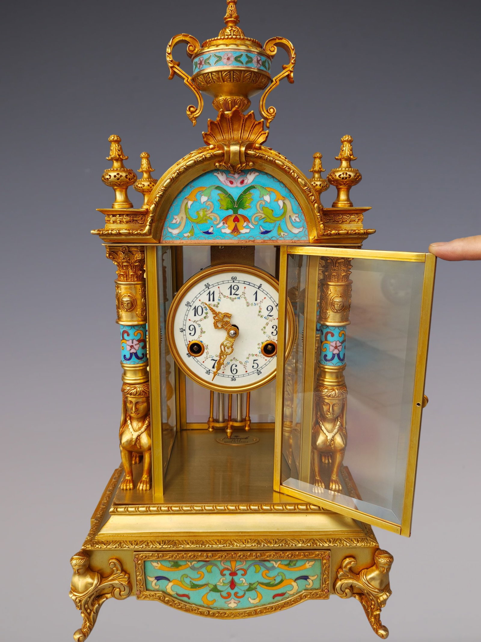 An Exquisite Gilt Bronze Lotus Pattern Clock: An Exquisite Gilt Bronze Lotus Pattern Clock Qing Dynasty, China Size:11.4inx8.7inx22.8in铜鎏金缠枝莲纹钟表 中国清代 Size: