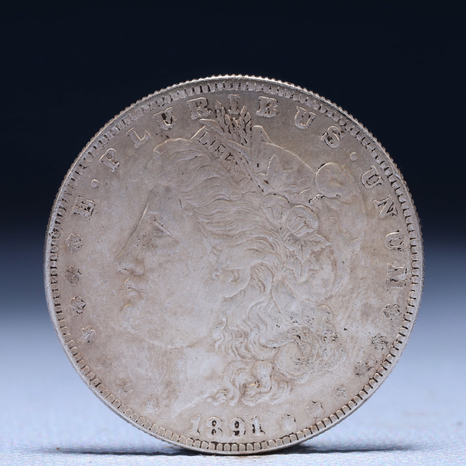 USA Morgan Dollar 1891 Coin: Obv: profile bust with date below and E PLURIBUS UNUM legend and stars around. Rev: eagle with In God we trust above within wreath with UNITED STATES OF AMERICA ONE DOLLAR legend. IN GOD WE TRUST /