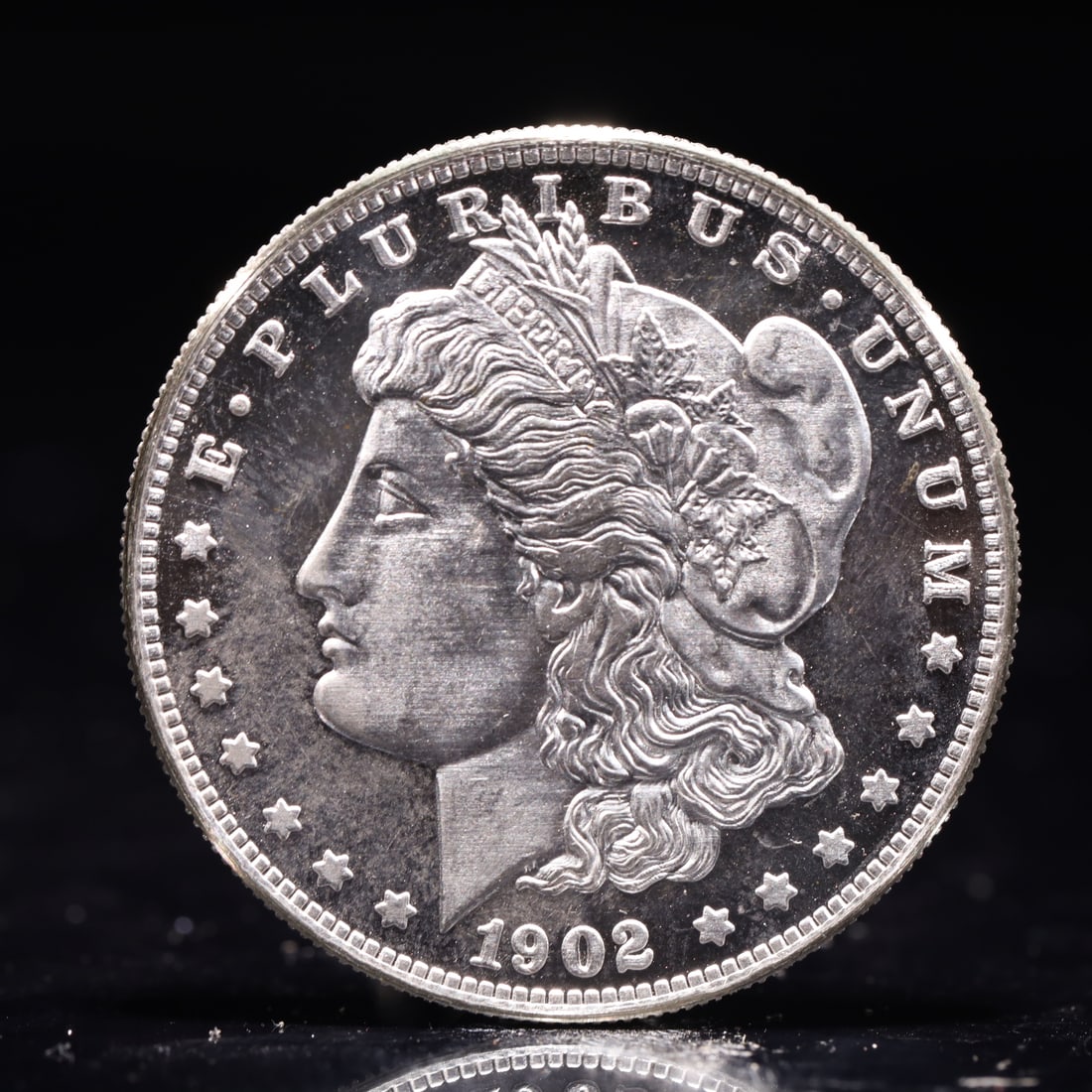 USA Morgan Dollar 1902 Coin: Obv: profile bust with date below and E PLURIBUS UNUM legend and stars around. Rev: eagle with In God we trust above within wreath with UNITED STATES OF AMERICA ONE DOLLAR legend. IN GOD WE TRUST / LI