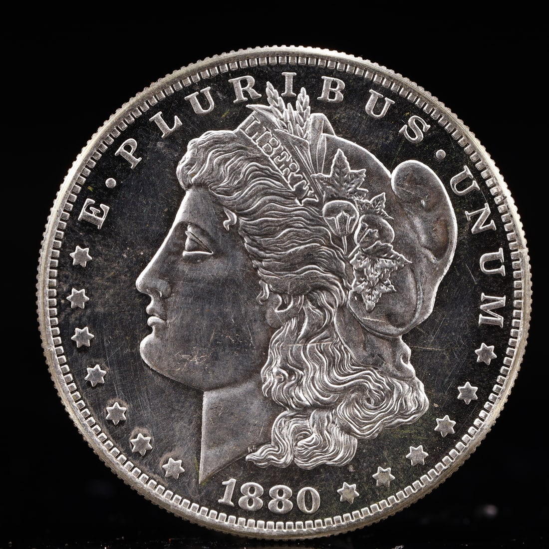 USA Morgan Dollar 1880 Coin: Obv: profile bust with date below and E PLURIBUS UNUM legend and stars around. Rev: eagle with In God we trust above within wreath with UNITED STATES OF AMERICA ONE DOLLAR legend. IN GOD WE TRUST / LI