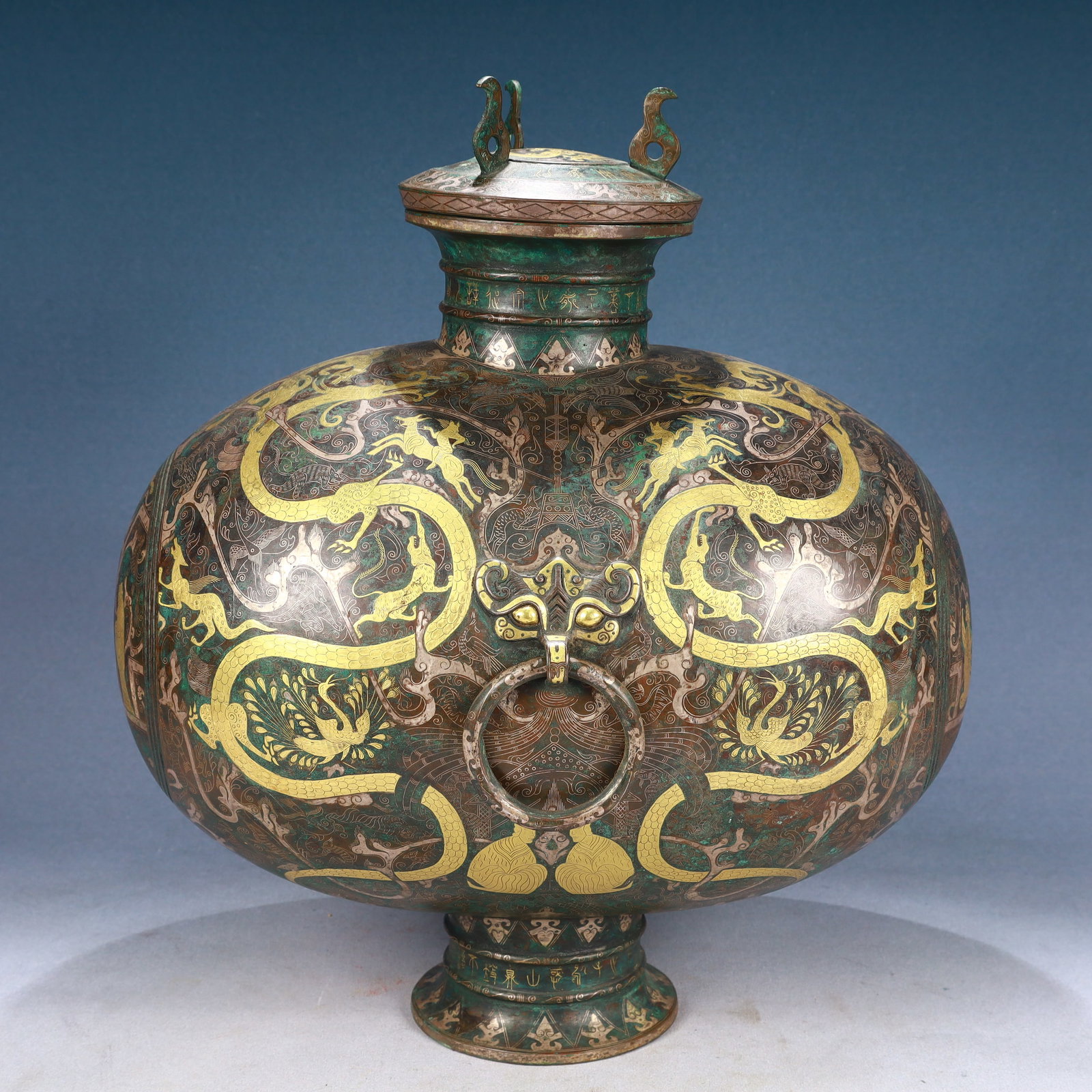 An Archaic Bronze Inlaid Gold and Silver Figure and Dragon Pattern Beast-Ears Cover Jar,With: An Archaic Bronze Inlaid Gold and Silver Figure and Dragon Pattern Beast-Ears Cover Jar,With Inscription,Qing Dynasty, China,Size:13.4inx9.1inx16.9in,Weight:6900g 青铜错金Ž