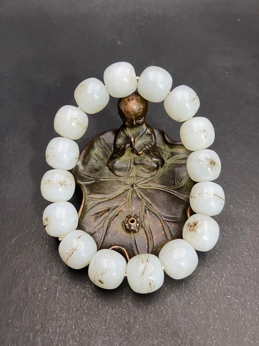 An Exquisite White Jade Bracelets: An Exquisite White Jade Bracelets Qing Dynasty, China Size:0.5inx0.6in Weight:72g白玉黑皮素面手链 中国清代 Size:1.36cmx1.4cm Wei