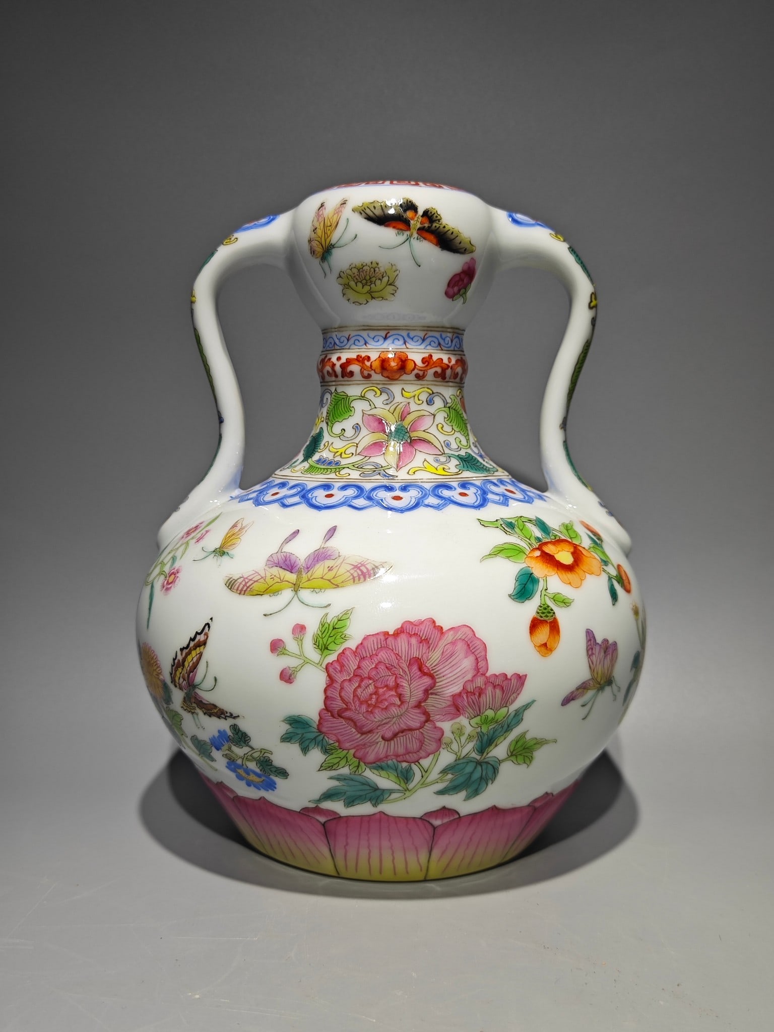 An Exquisite Famille-Rose Flower and Butterfly Pattern Double-Ears Vase: An Exquisite Famille-Rose Flower and Butterfly Pattern Double-Ears Vase Qing Dynasty, China Qianlong Six-character Mark