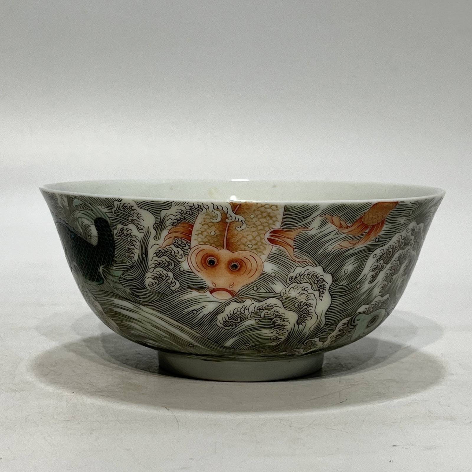 An Exquisite Ink Color Famille-Rose Seawater Fish Pattern Bowl: An Exquisite Ink Color Famille-Rose Seawater Fish Pattern Bowl,Qing Dynasty,China,Kangxi Six-character Mark,Size:6.4in 墨彩粉彩海水鱼纹碗,中