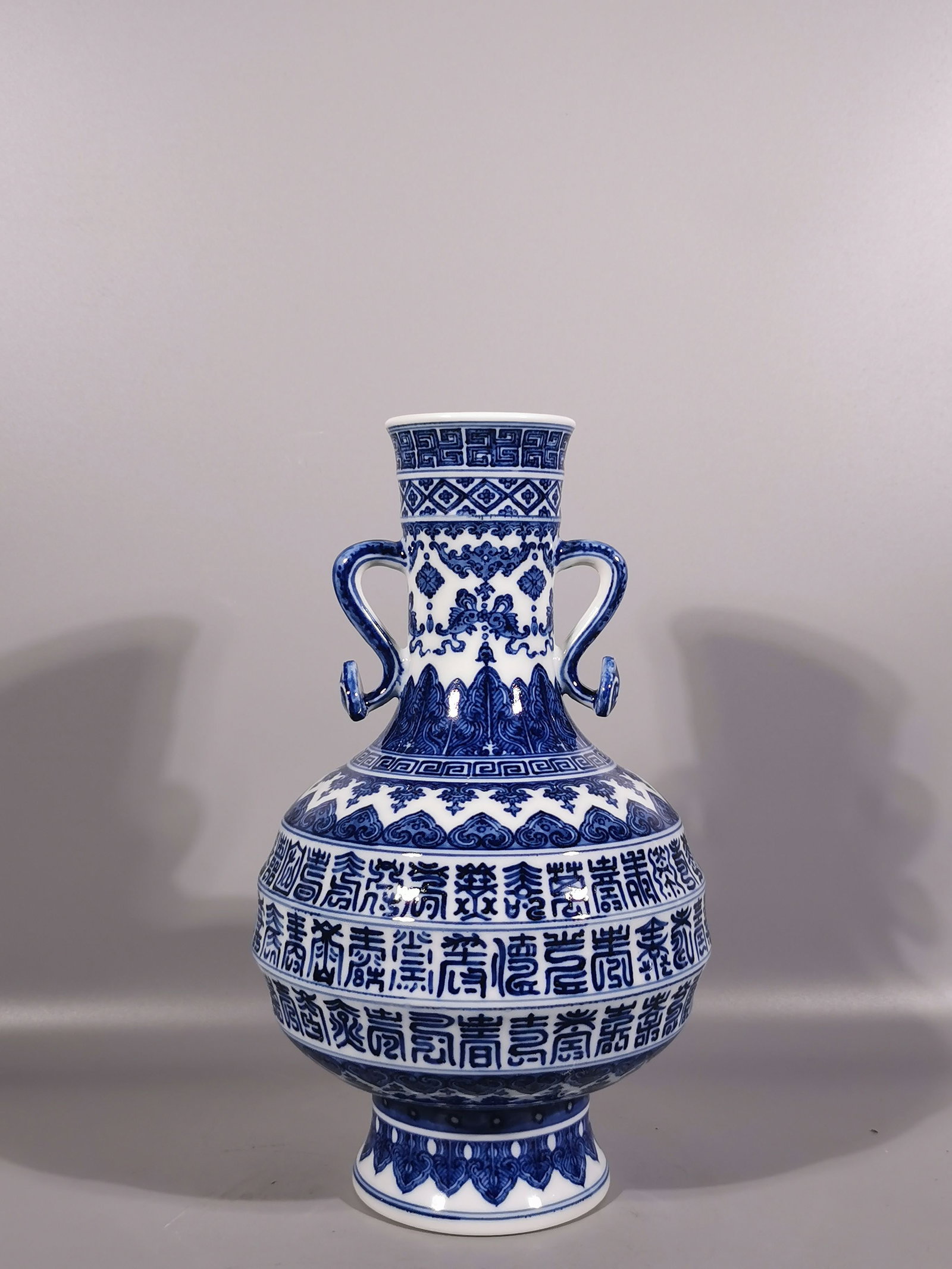 A Exquisite Blue and White Bats and Peach Pattern Ruyi-Ears Vase: A Exquisite Blue and White Bats and Peach Pattern Ruyi-Ears Vase,Qing Dynasty, China,Qianlong Six-character Mark,Size:11.3inx2.8inx6.9in 青花福寿纹如意耳