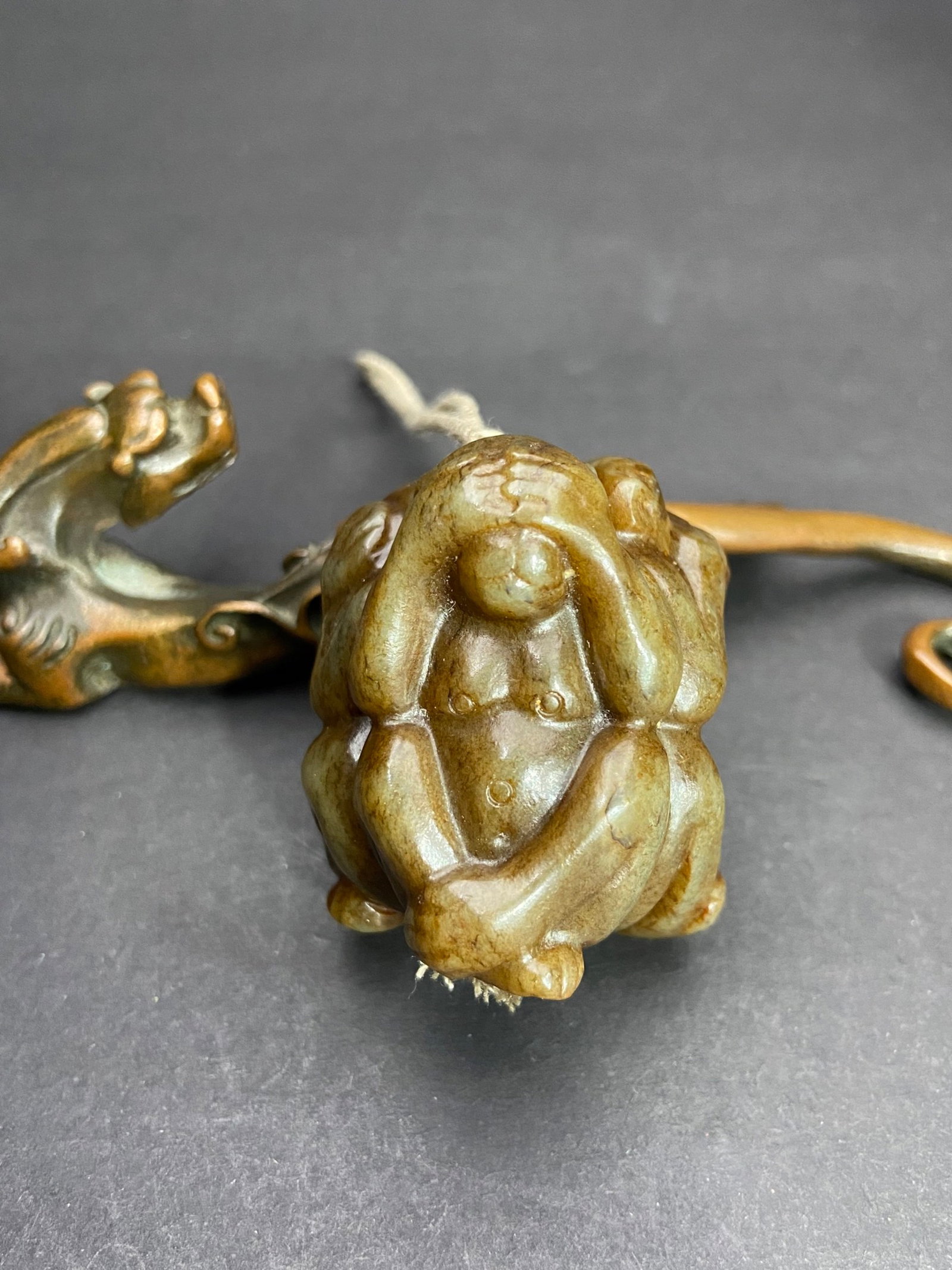 An Exquisite White Jade Monkey Pendant: An Exquisite White Jade Monkey Pendant,Qing Dynasty,China,Size:43.6mmx38.8mm,Weight:87g 白玉猴挂件,中国清代