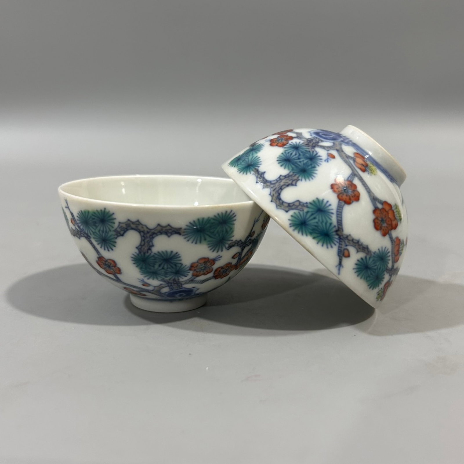 A Pair of Exquisite Doucai Pine,Bamboo and Plum Blossom Pattern Cups: A Pair of Exquisite Doucai Pine,Bamboo and Plum Blossom Pattern Cups,Qing Dynasty,China,Yongzheng Six-character Mark,Size:3inx1.8in 一对斗彩松竹梅纹