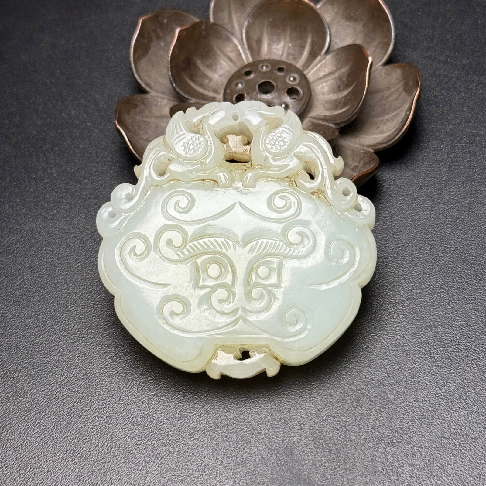 An Exquisite White Jade Beast-Face and Phoenix Pattern Pendant: An Exquisite White Jade Beast-Face and Phoenix Pattern Pendant,Qing Dynasty,China,Size:52mmx51mmx12.5mm,Weight:62g 白玉兽面凤纹挂件,中国