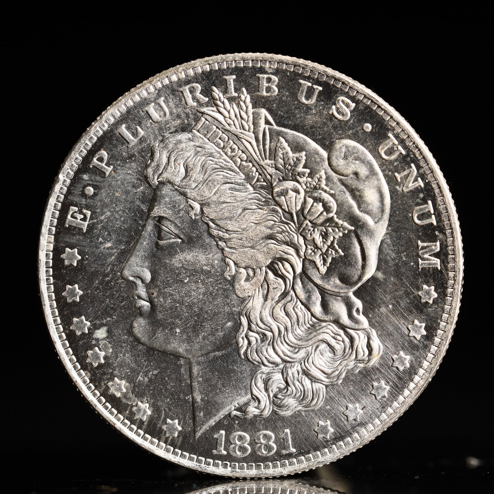 USA Morgan Dollar 1881 Coin: Obv: profile bust with date below and E PLURIBUS UNUM legend and stars around. Rev: eagle with In God we trust above within wreath with UNITED STATES OF AMERICA ONE DOLLAR legend. IN GOD WE TRUST / LI