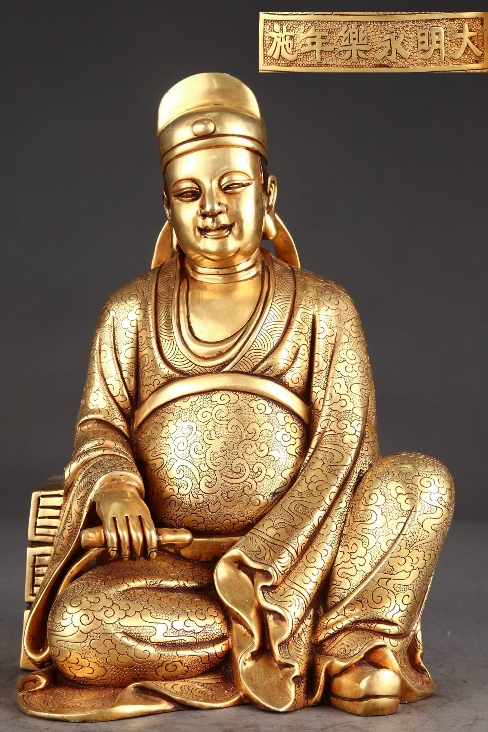 A Solemn Gilt Bronze Auspicious Cloud Pattern Statue of Figure: A Solemn Gilt Bronze Auspicious Cloud Pattern Statue of Figure,Ming Dynasty,China,Yongle Six-character Mark,Size:11.8inx7.5in,Weight:8250g 铜鎏金祥云纹人Ĥ