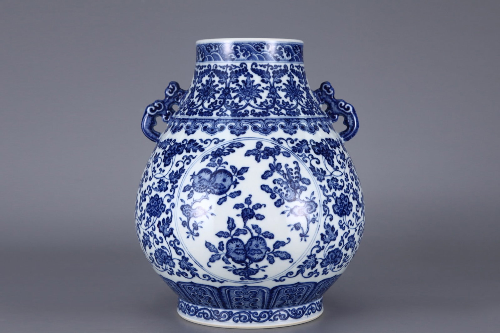 An Exquisite Blue and White Lotus Pattern Flower and Fruit Pattern Double-Ears Vase: An Exquisite Blue and White Lotus Pattern Flower and Fruit Pattern Double-Ears Vase Qing Dynasty, China Qianlong Six-character Mark Size:13inx11.4in青花三多纹双 