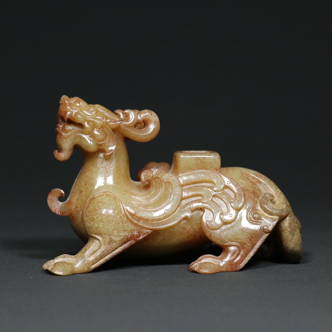 An Exquisite White Jade Auspicious Beast Ornament: An Exquisite White Jade Auspicious Beast Ornament Han Dynasty, China Size:5.3inx2.6inx3.3in Weight:537g白玉瑞兽神兽摆件 中国汉代