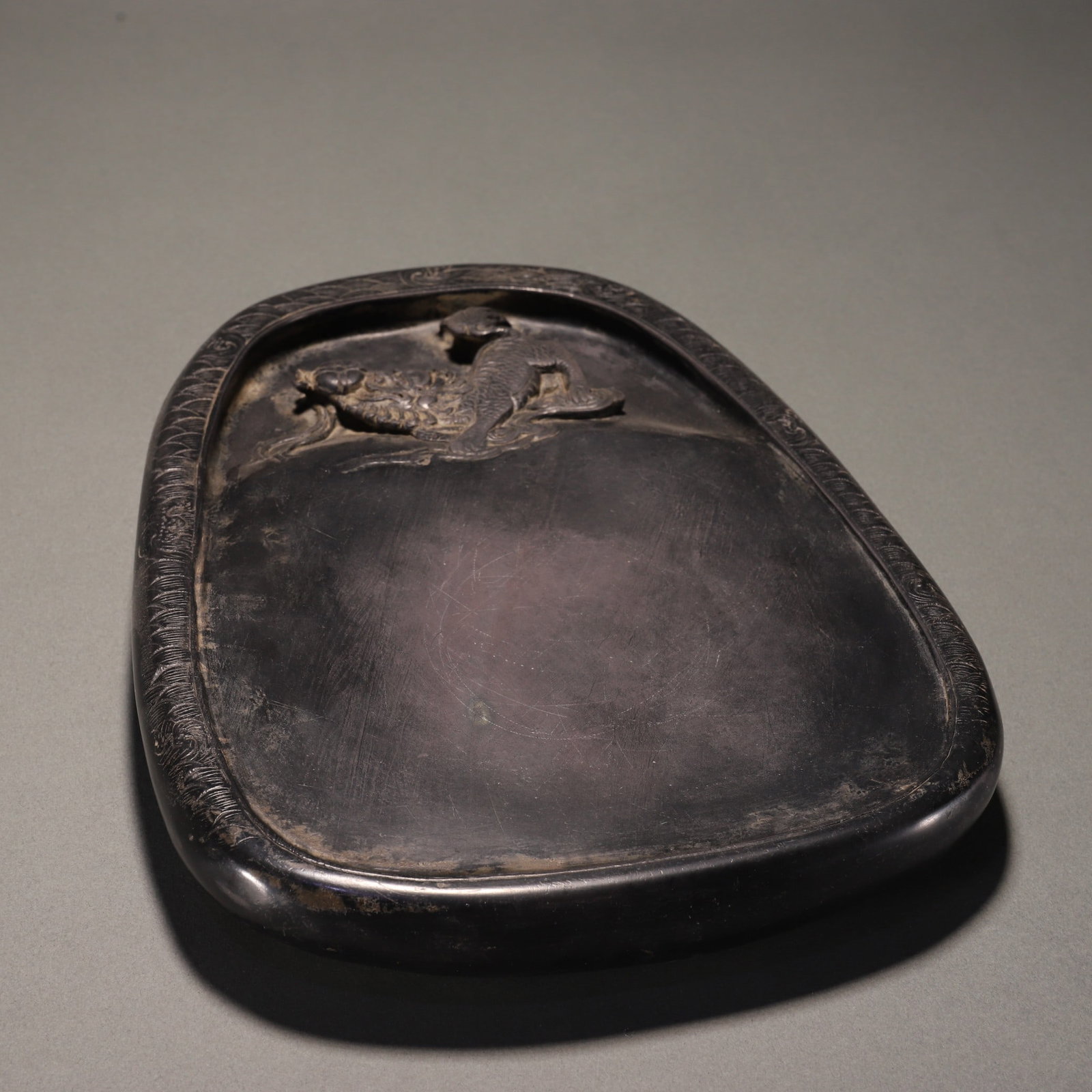 An Exquisite Lion Pattern Inkstone: An Exquisite Lion Pattern Inkstone Qing Dynasty, China Size:1.6inx12.2inx23??端石狮子戏球纹砚台 中国清代 Size:4cmx31cmx23&