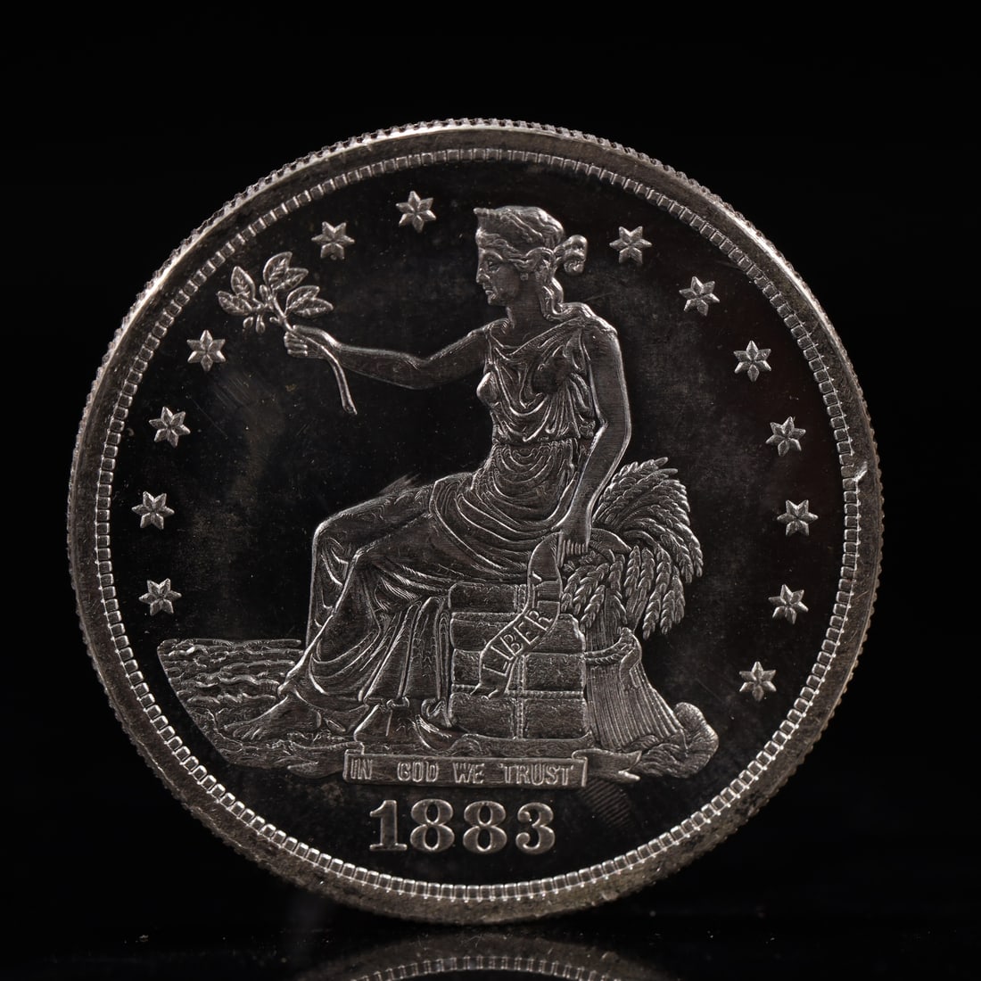 USA Trade Dollar 1883 Coin: American coin. Obverse: Liberty seated on a pedestal facing the sea to the left holding olive branches surrounded by 13 stars. IN GOD WE TRUST / LIBERTY / 1883. Reverse: An eagle holding branches with