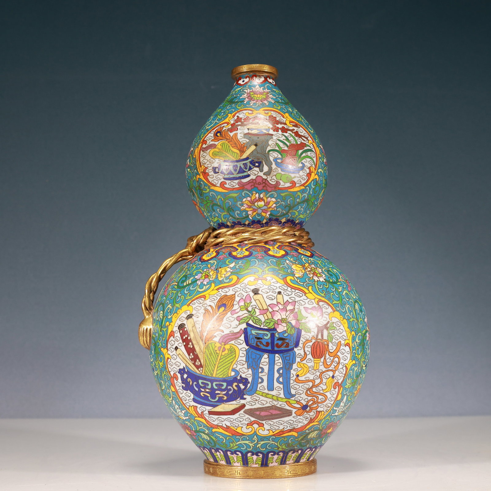 A Rare Cloisonne Lotus and Bogu Pattern Gourd-Shaped Vase: Estimated Value:6400-12800 A Rare Cloisonne Lotus and Bogu Pattern Gourd-Shaped Vase,Qing Dynasty, China,Qianlong Four-character Mark,Size:6.7inx14.6in,Weight:5250g