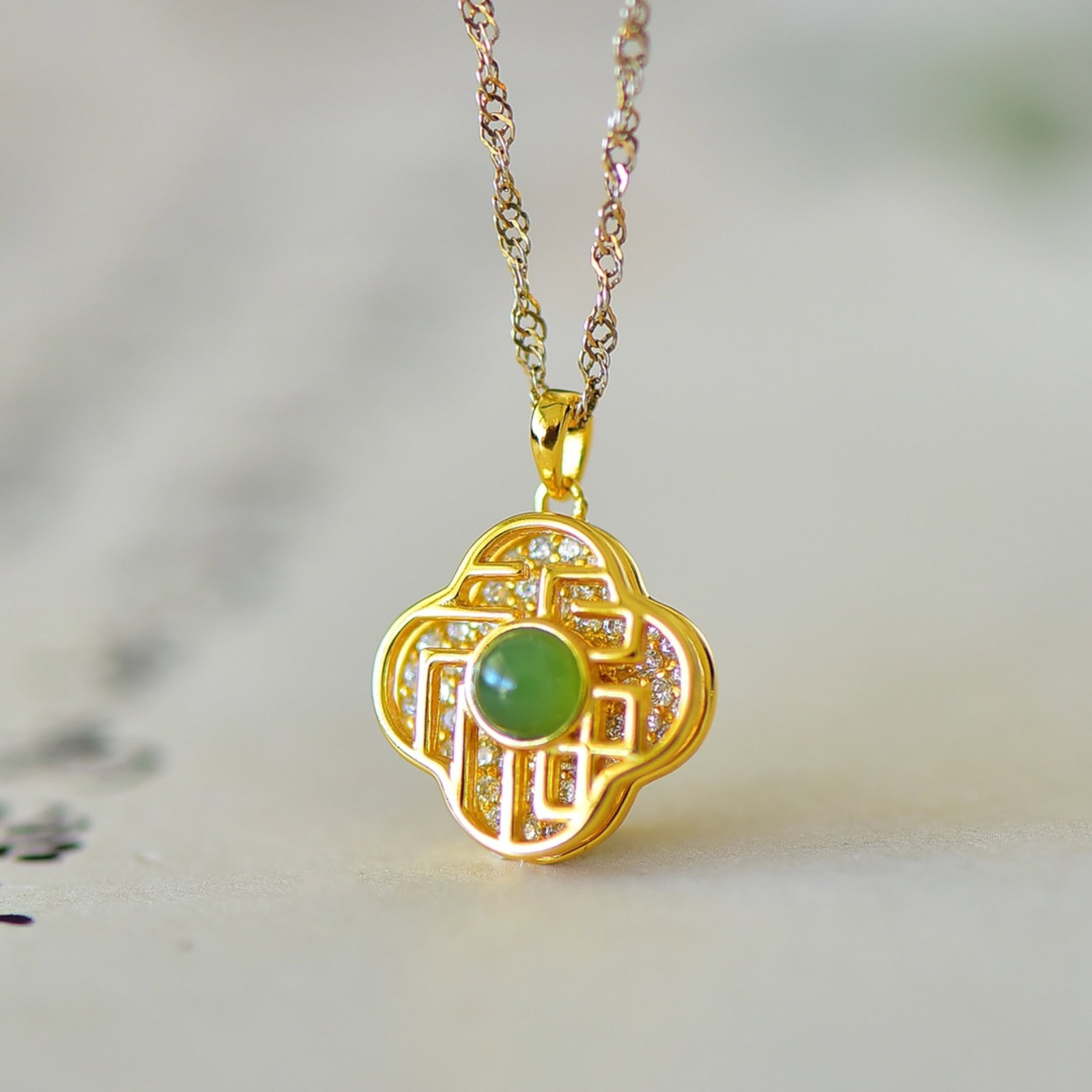An Exquisite Sterling Silver-Gold Plated Inlaid White Jade Pendant: Estimated Value:200-400 An Exquisite Sterling Silver-Gold Plated Inlaid White Jade Pendant,Size:4mmx4mm 纯银镀金镶白玉吊坠