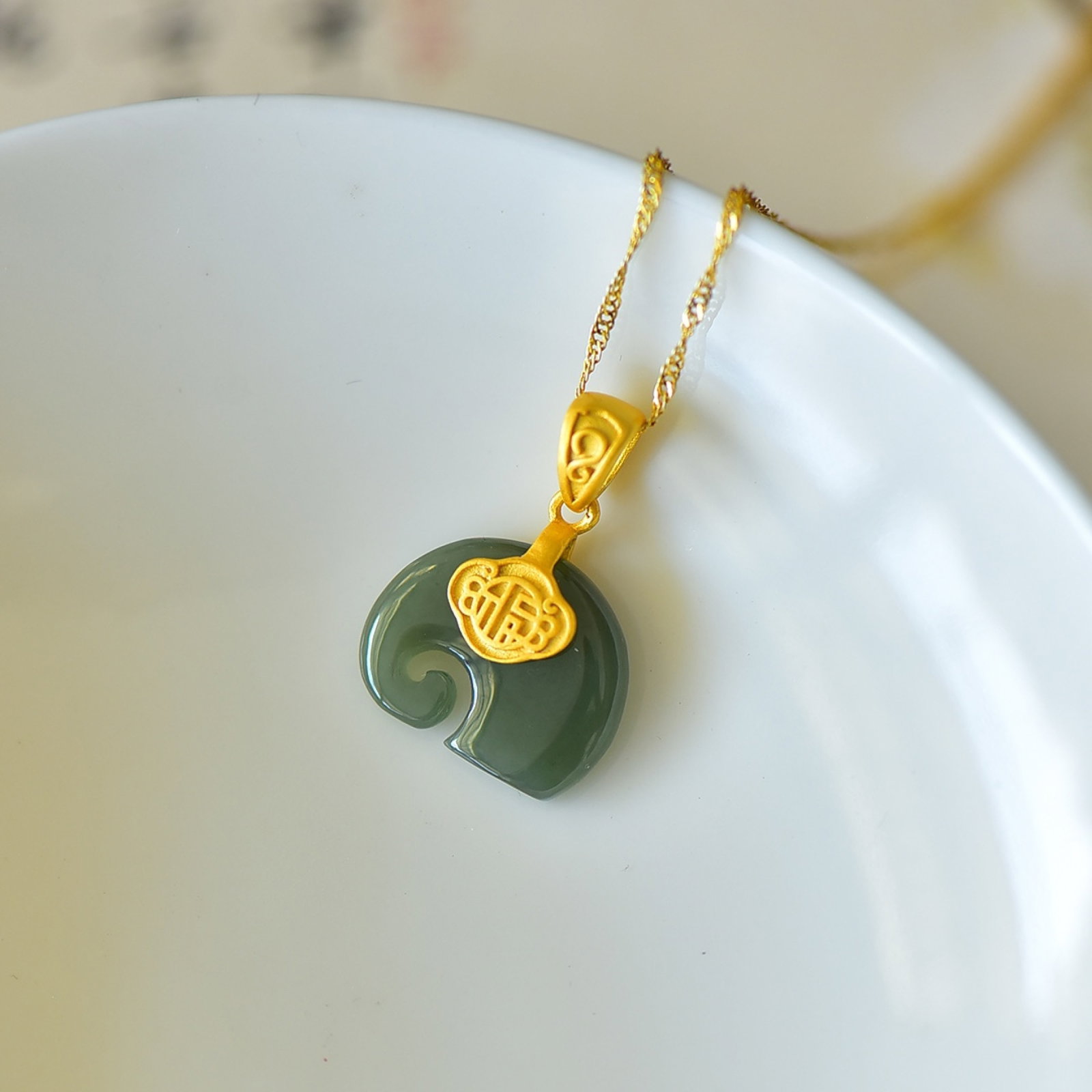 An Exquisite Sterling Silver-Gold Plated Inlaid Greenish Jade Pendant: Estimated Value:200-400 An Exquisite Sterling Silver-Gold Plated Inlaid Greenish Jade Pendant,Size:14mmx17mm 纯银镀金镶青玉吊坠