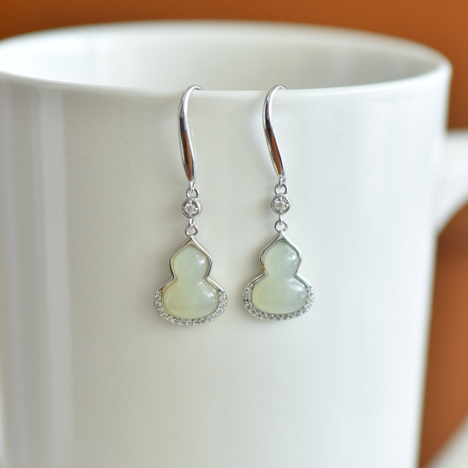 A Pair of Exquisite Sterling Silver Inlaid White Jade Gourd Earrings,Inlaid Diamond: Estimated Value:300-600 A Pair of Exquisite Sterling Silver Inlaid White Jade Gourd Earrings,Inlaid Diamond,Size:8mmx11mm