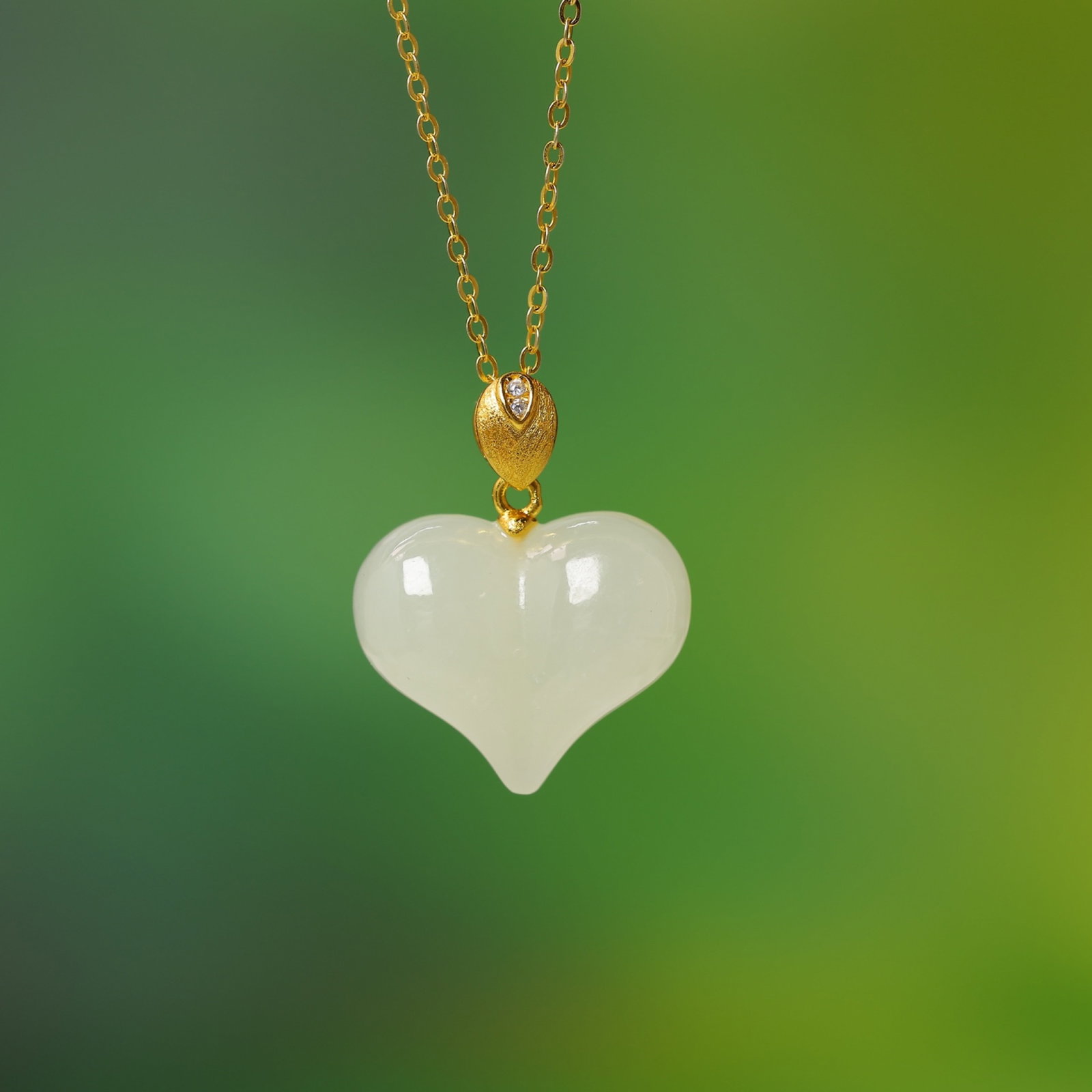 An Exquisite Sterling Silver-Gold Plated Inlaid White Jade Pendant: Estimated Value:400-800 An Exquisite Sterling Silver-Gold Plated Inlaid White Jade Pendant,Size:15mmx18mm 纯银镀金镶白玉吊坠